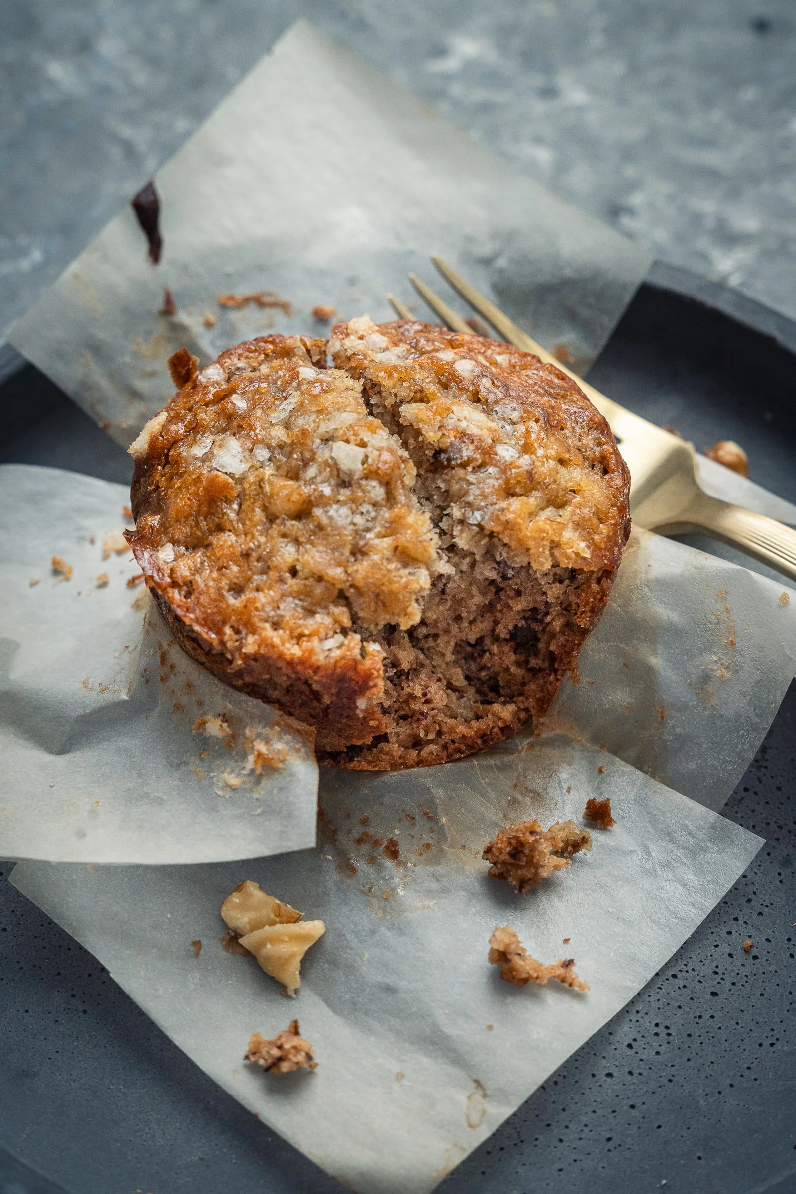 Artisanal Banana Walnut Muffin Detail
High-detail macro photography showcasing the golden texture and crumb of a fresh-baked artisanal banana walnut muffin