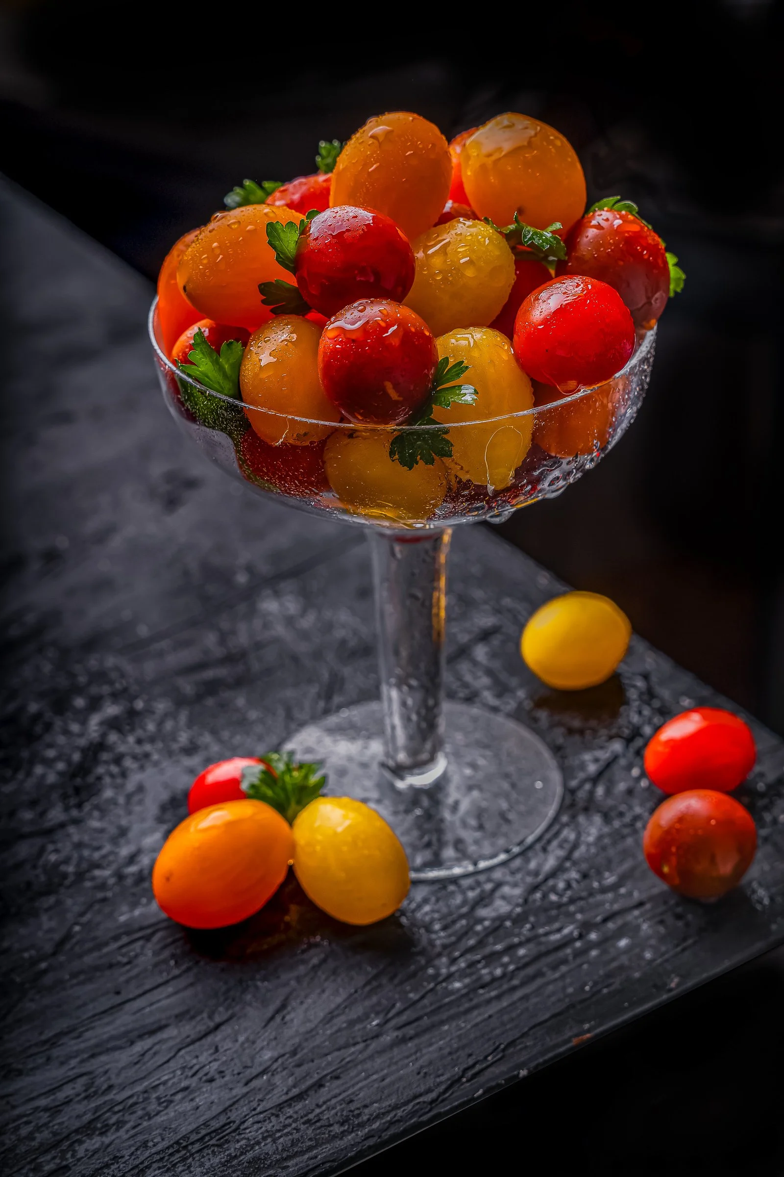 Cherry Tomato Study | Conceptual Food Photography
Fine art food photography featuring vibrant red and yellow cherry tomatoes served in a crystal coupe glass. This high-detail study highlights water droplets, fresh textures, and dramatic lighting on a