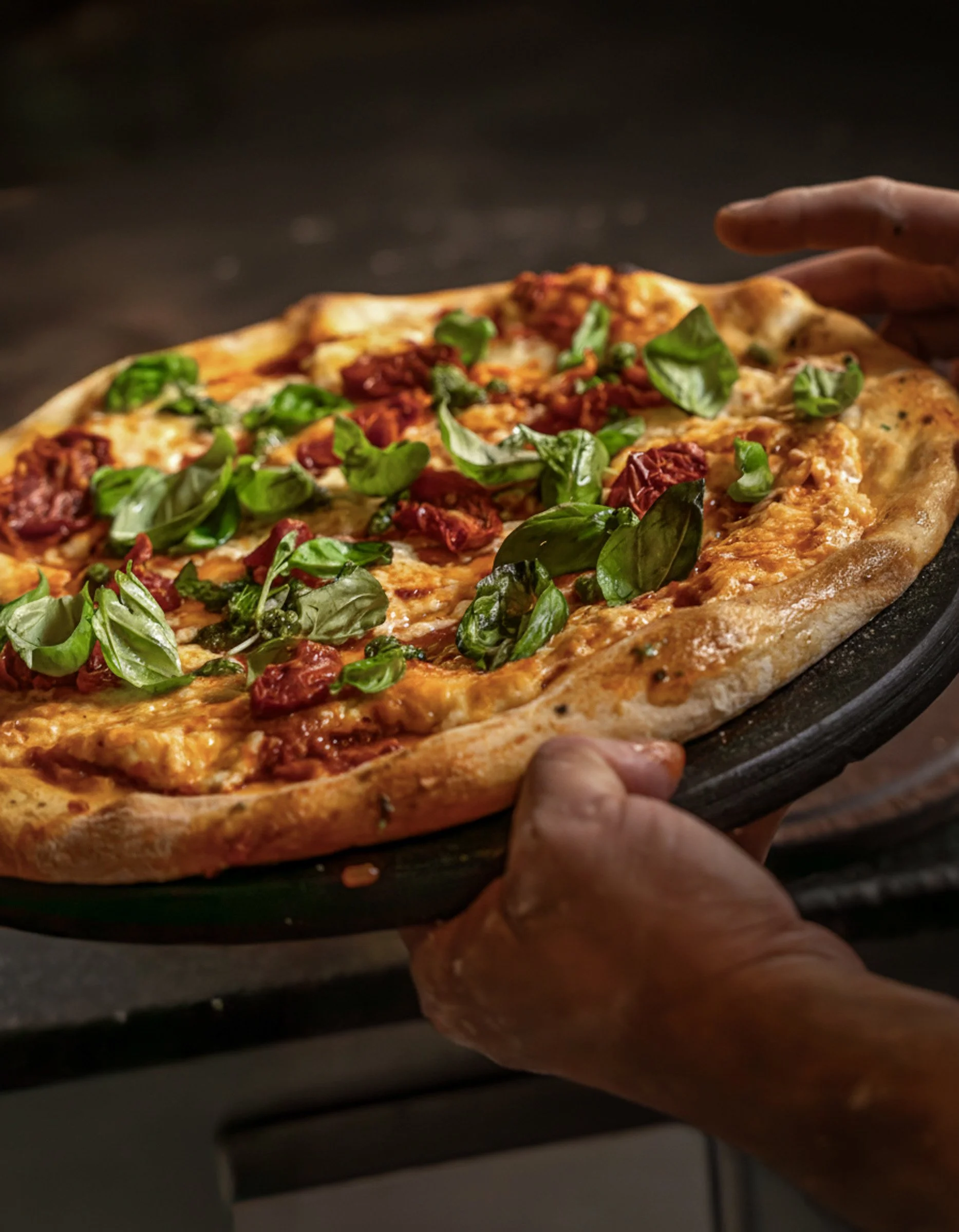 Artisanal Pizza & Rustic Dough Texture
Commercial food photography capturing the charred crust, vibrant basil, and melted textures of an artisanal pizza in a moody, rustic setting.