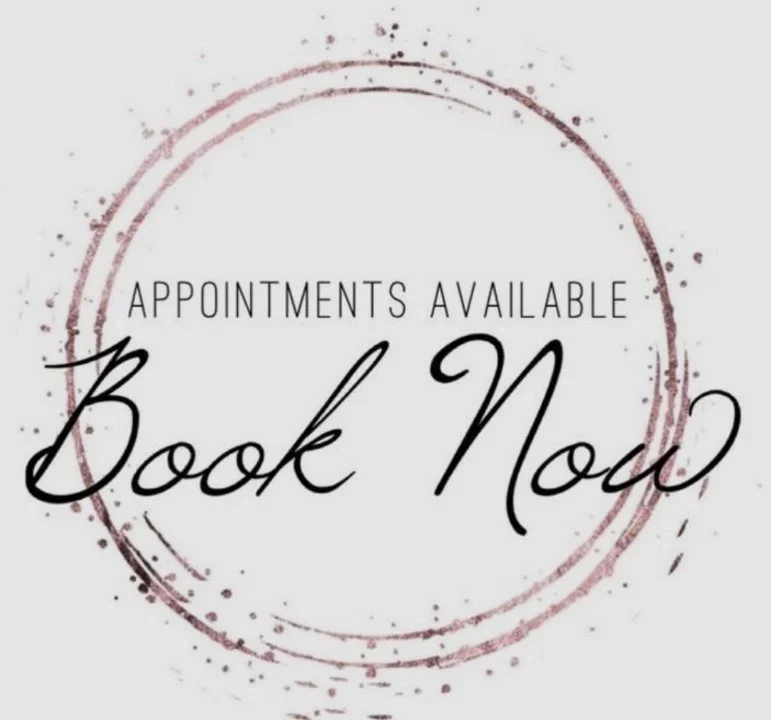 A circular graphic with a pinkish-red outline and splashes, containing the text "APPOINTMENTS AVAILABLE" at the top and "Book Now" in large, elegant script in the center.