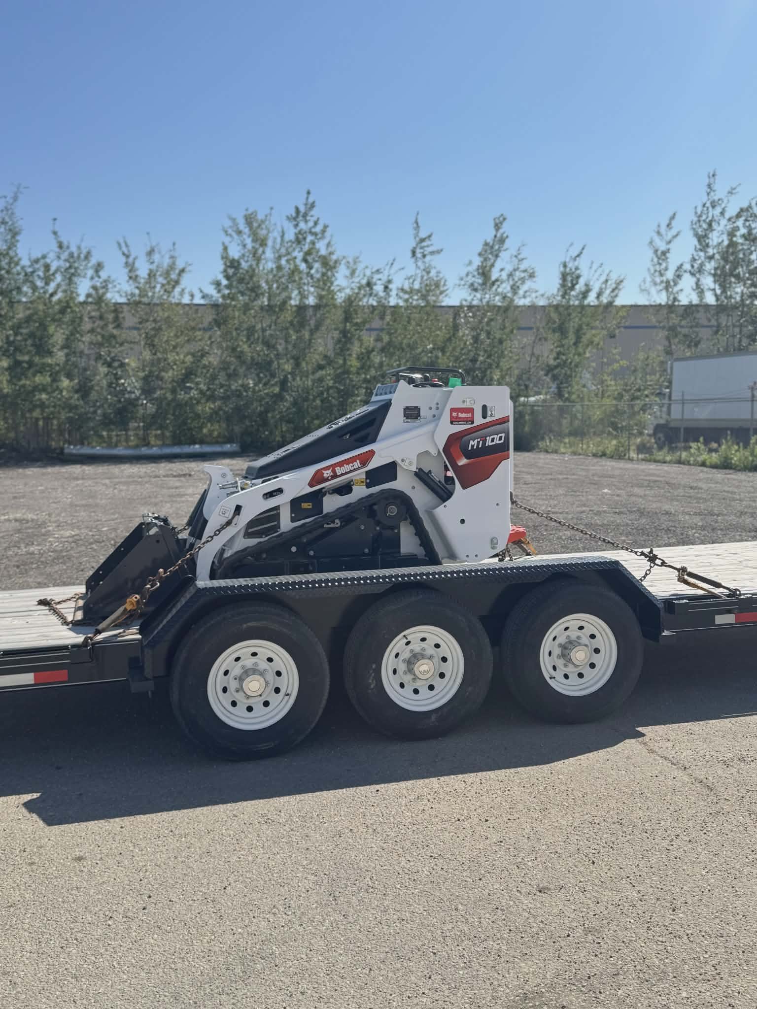 Alberta screw pile contractor operating skid steer drilling equipment