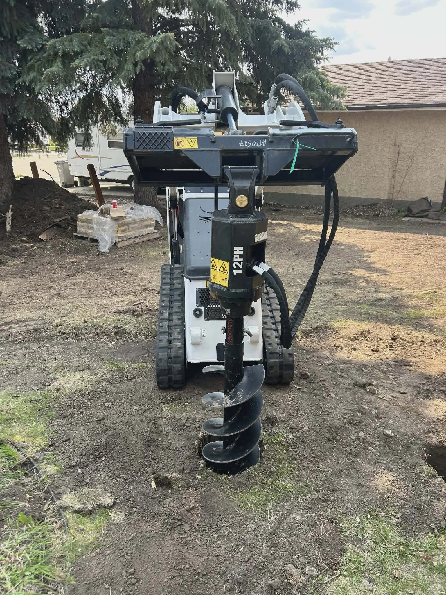 Residential screw pile installation equipment at Alberta construction site