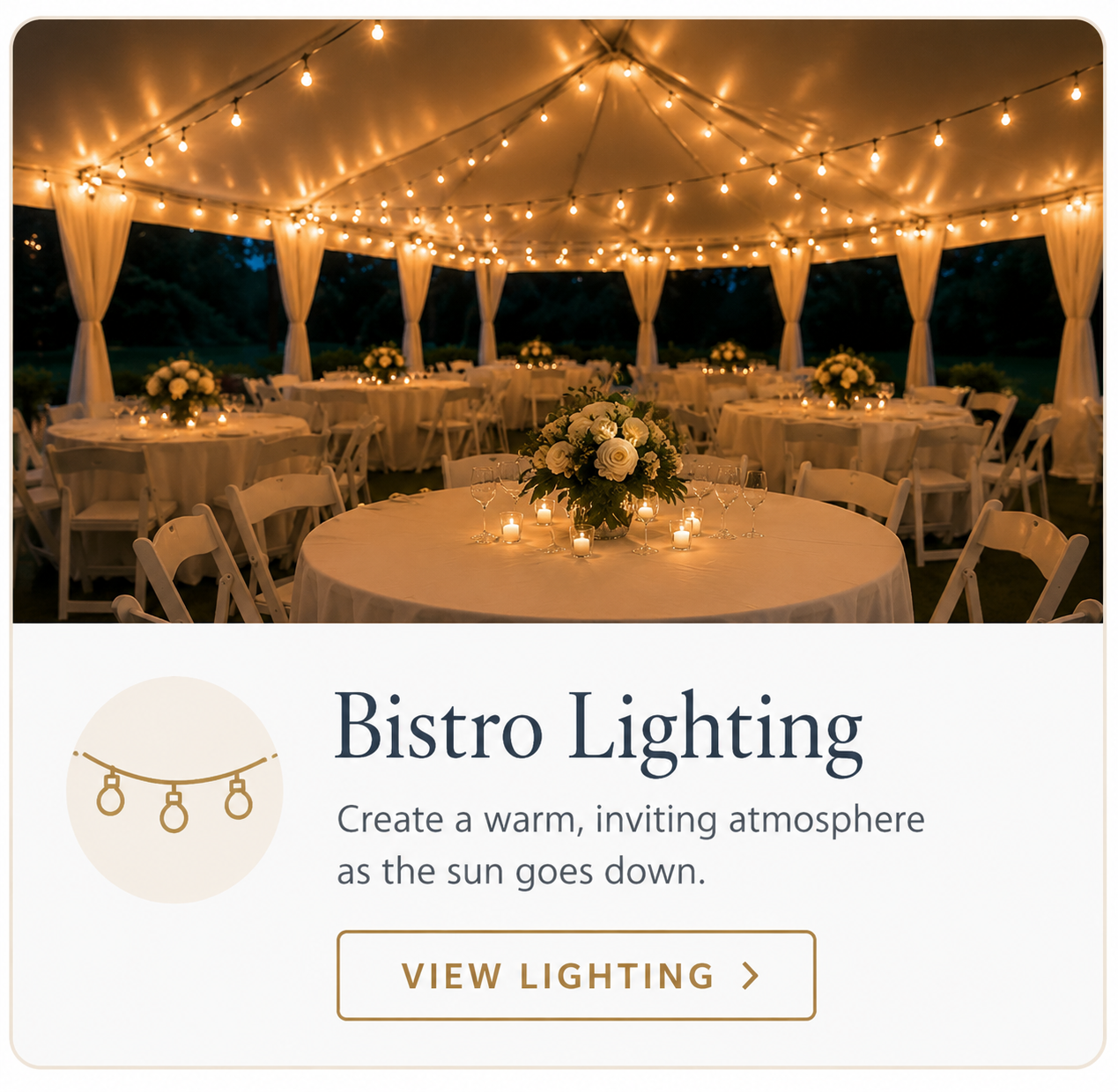 Elegant wedding reception beneath a white tent illuminated with warm bistro string lighting, creating a romantic evening atmosphere for guests.