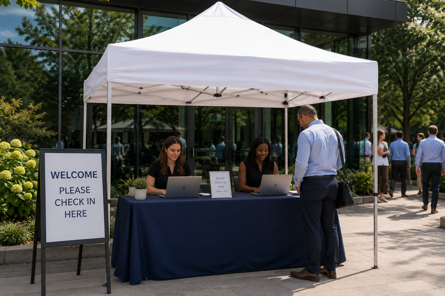 Commercial 10×10 white pop-up tent serving as a corporate event registration and check-in station outside a modern office building in Baltimore, Maryland.