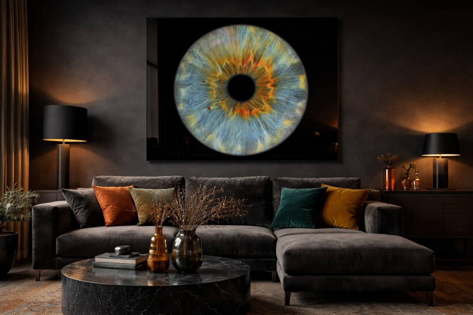 Living room with a dark grey sectional sofa decorated with colorful pillows, a black marble coffee table with vases and books, large painting of a colorful eye on the wall, and two lamps with black shades on either side.