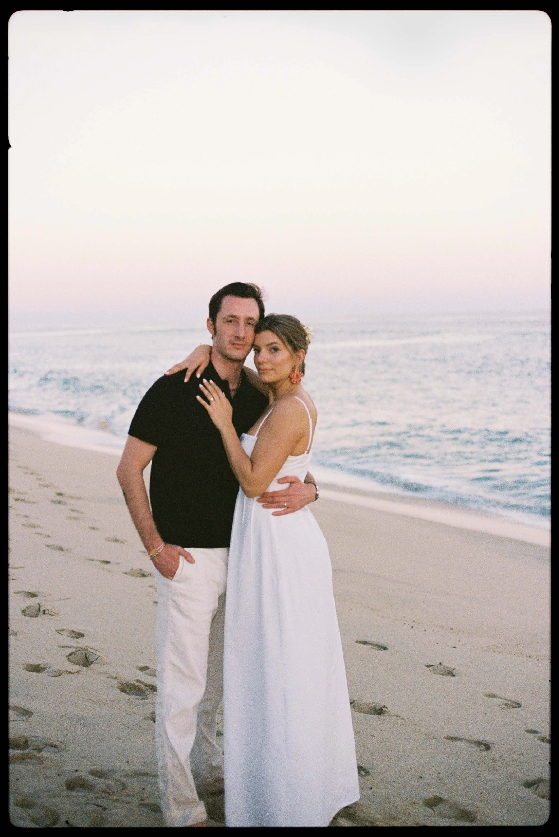 Bride and Groom pose on the beach during their Welcome Dinner in Cabo San Lucs