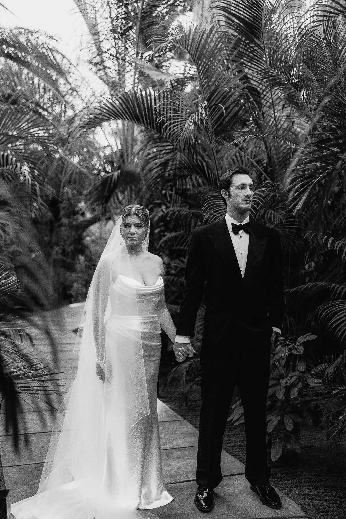 Bride and Groom holding hands and looking on the side