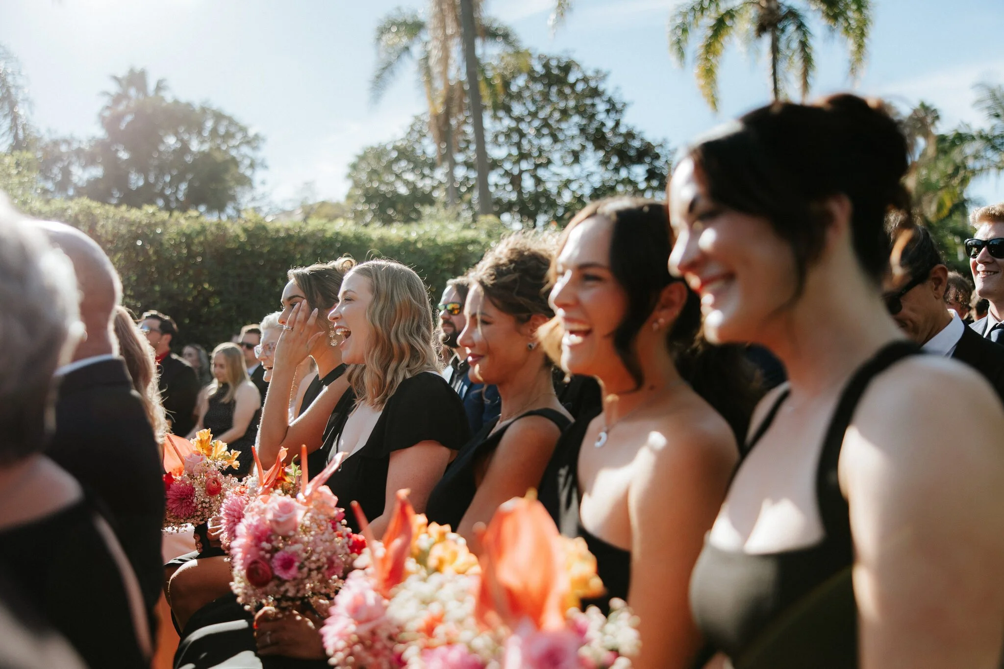 Bridesmaids laugh and cry with emotion during wedding ceremony