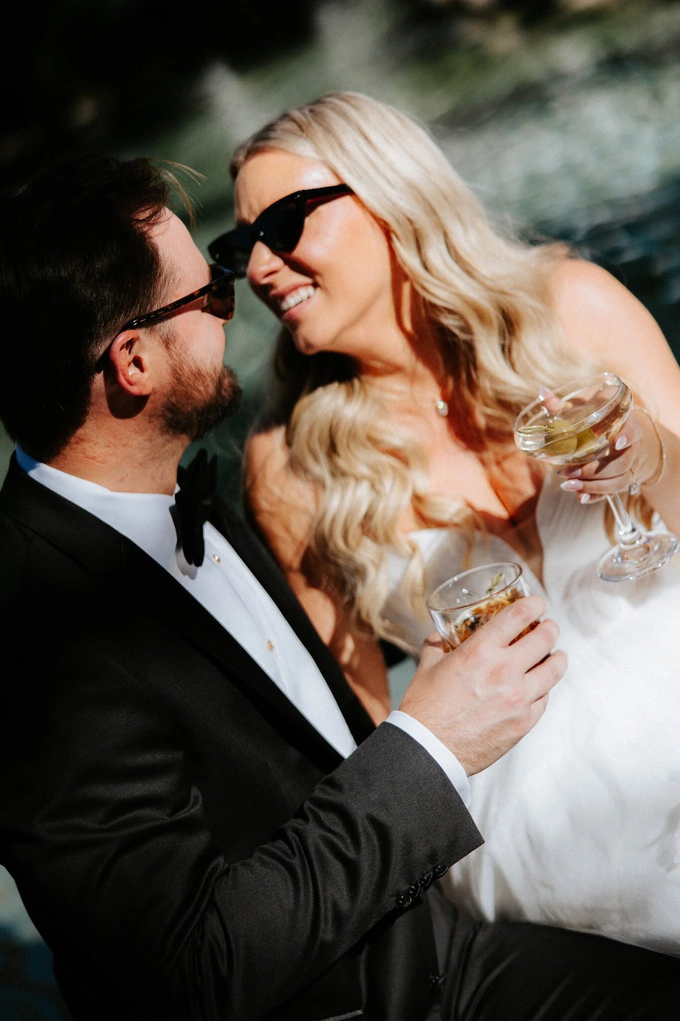Bride and Groom cheering with a cocktail and smiling at each other