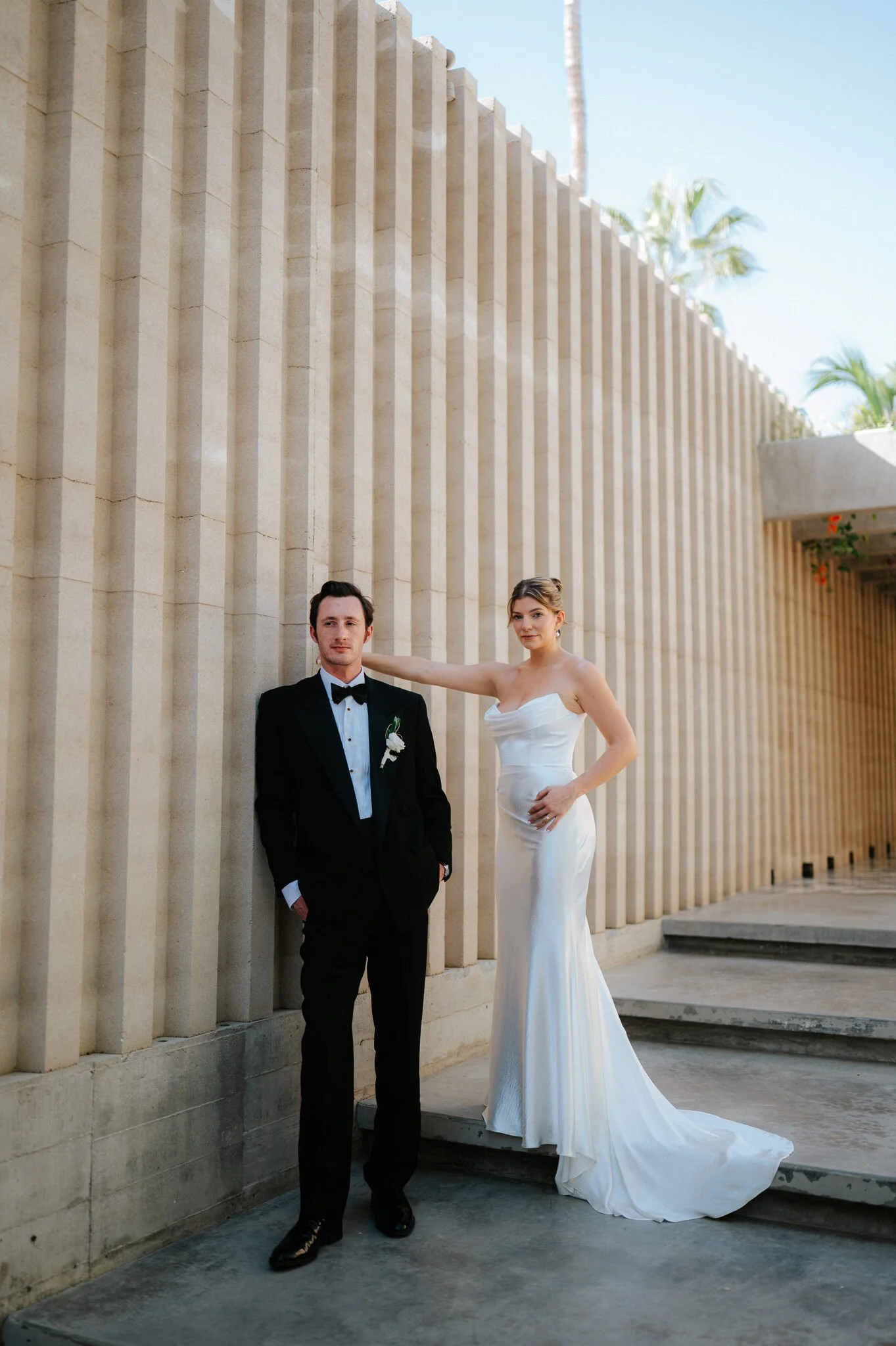 Editorial Pose Bride and Groom against a concrete wall