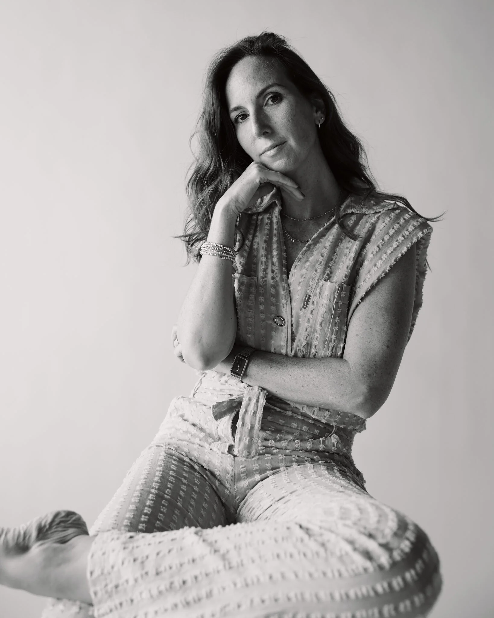 women posing with her chin on her hand looking at the camera