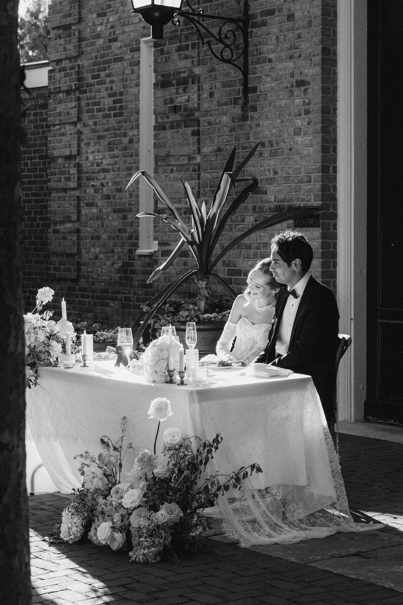 Bride and Groom smile at at toast speaker during reception
