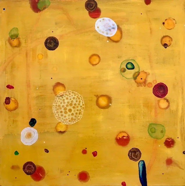 Abstract painting with various colorful circular and irregular shapes on a yellow background.