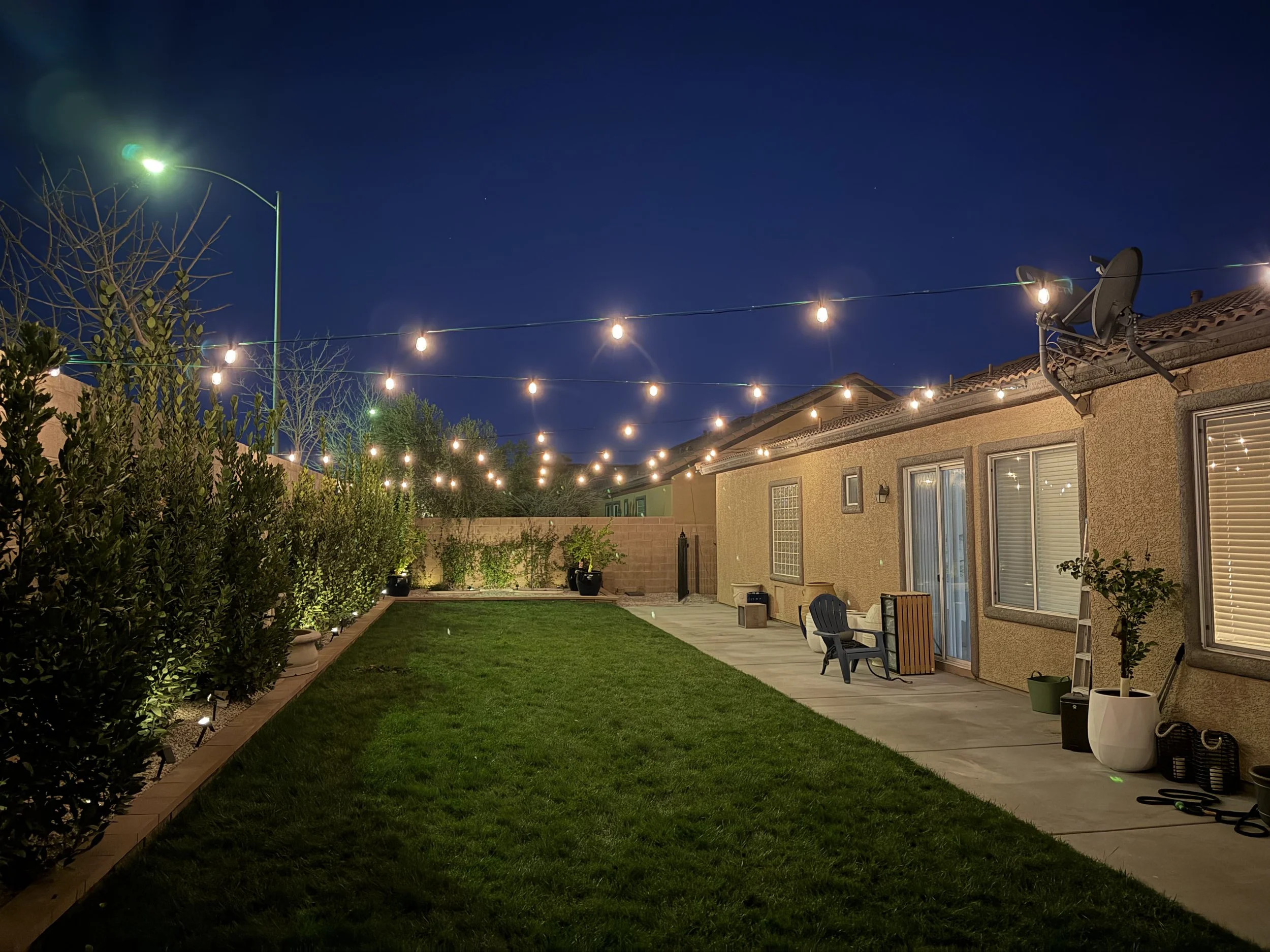Backyard bistro lighting installation in Las Vegas with string lights over patio