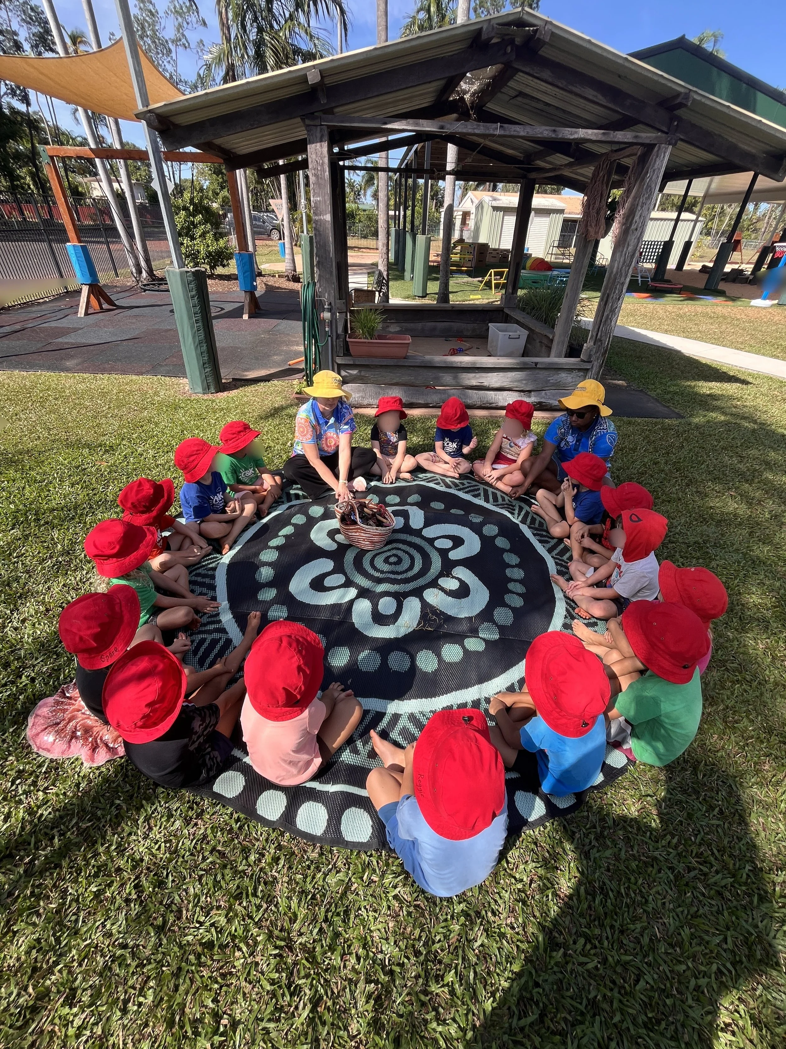 children sitting on mat 