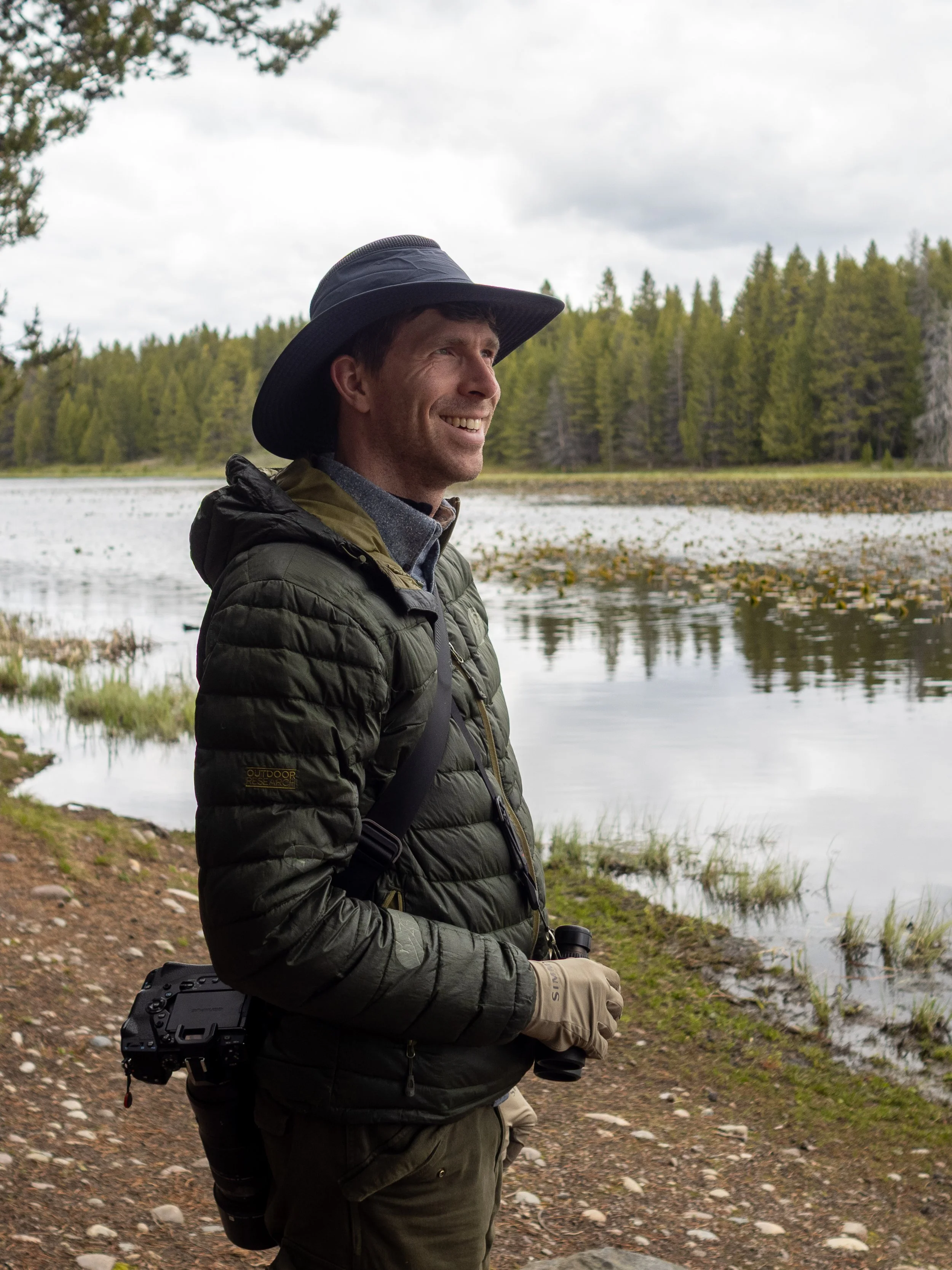 Photographer Stephen Tarnowski holding a pair of binoculars