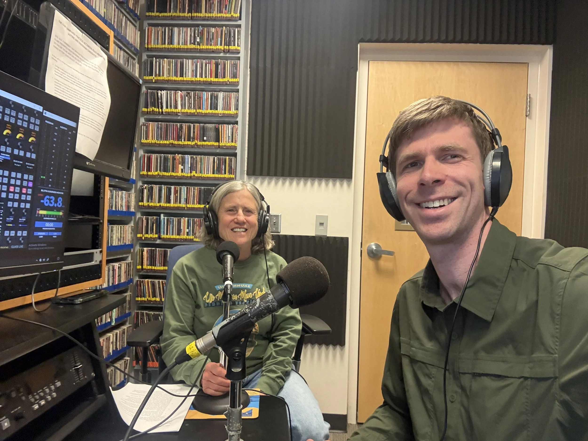 Lisa and Stephen in the recording studio wearing headphones and in front of recording mics