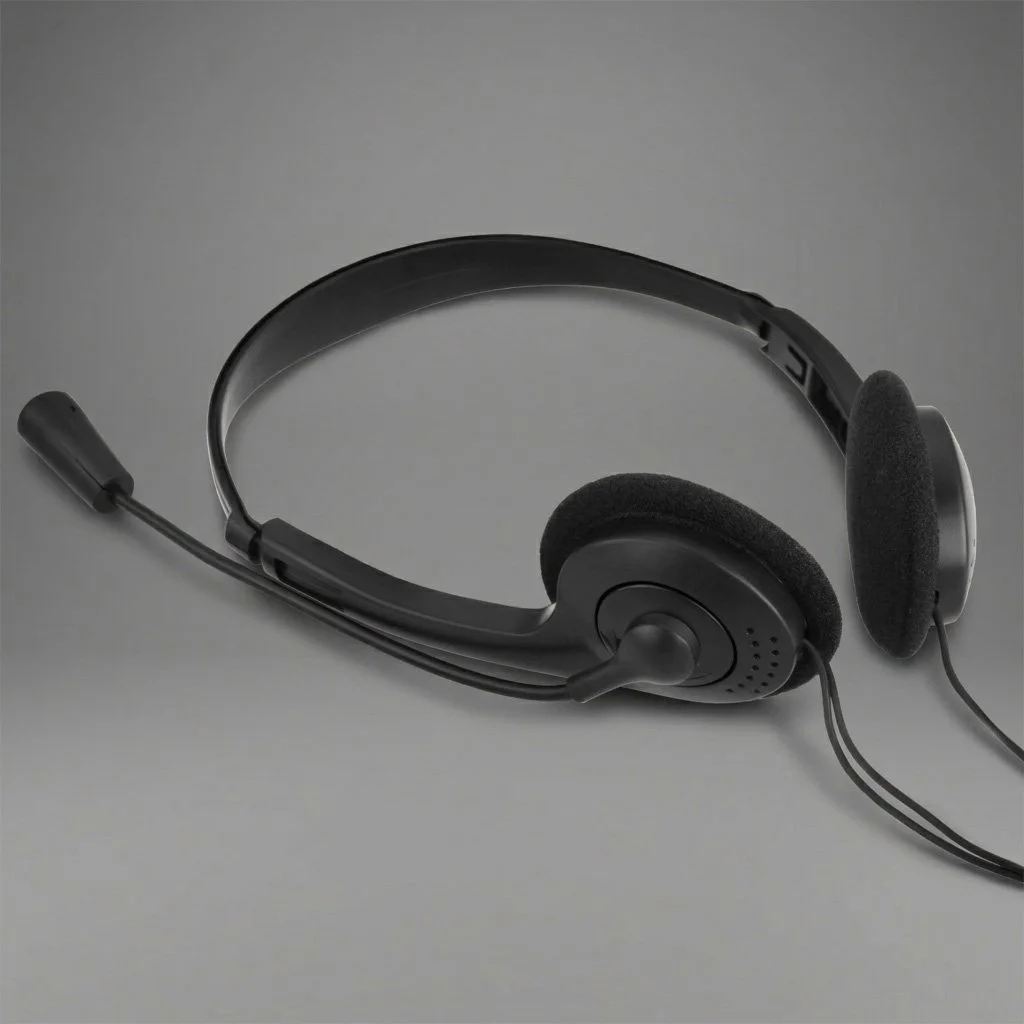 Black headset with microphone on a gray background.