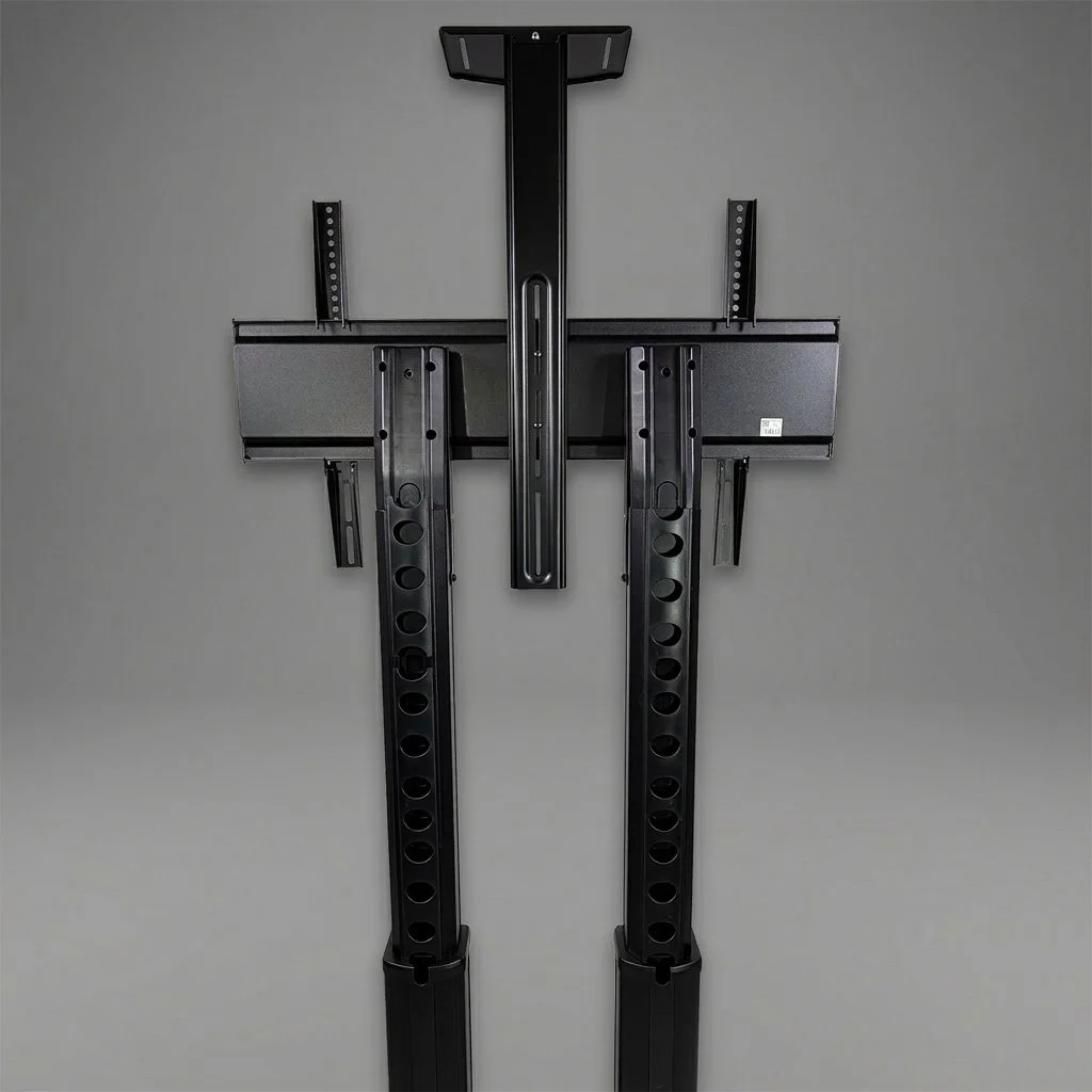 Wall-mounted adjustable TV wall mount bracket with arms extended on a gray wall.