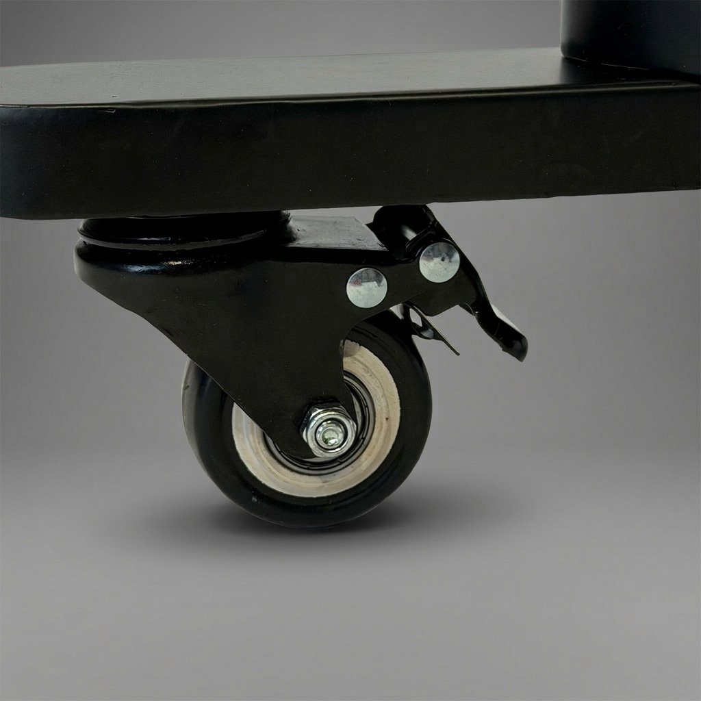 Close-up of a caster wheel attached to the bottom of a piece of equipment or furniture, with a gray background.