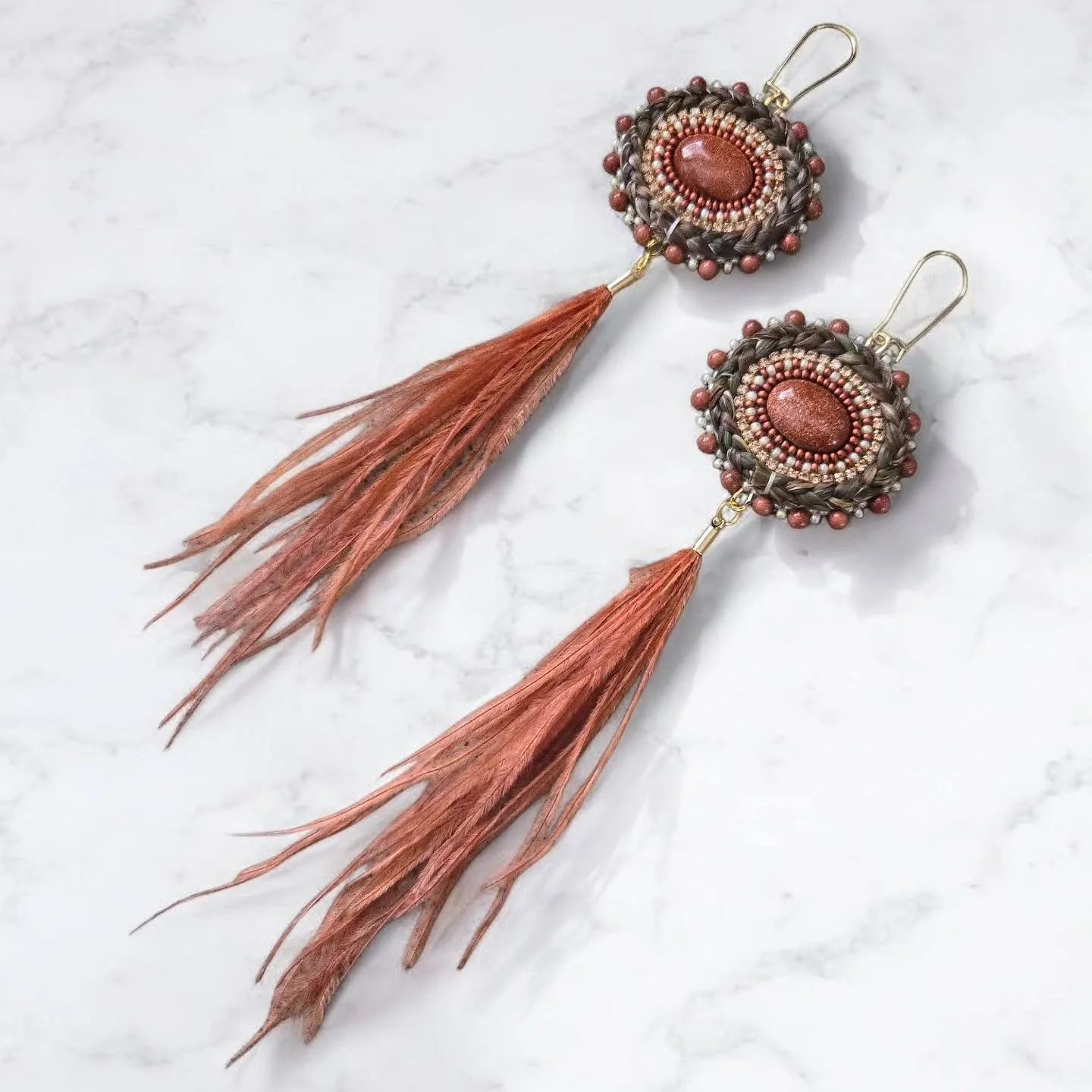 ***AVAILABLE***

Sienna sweetgrass earrings featuring golden sandstone center cabochons, topaz rhinestone chain, golden sandstone edging beads and feather tassles. Set on 18k gold-plated kidney hooks.

Priced at $155 Canadian plus $15 shipping. Pleas