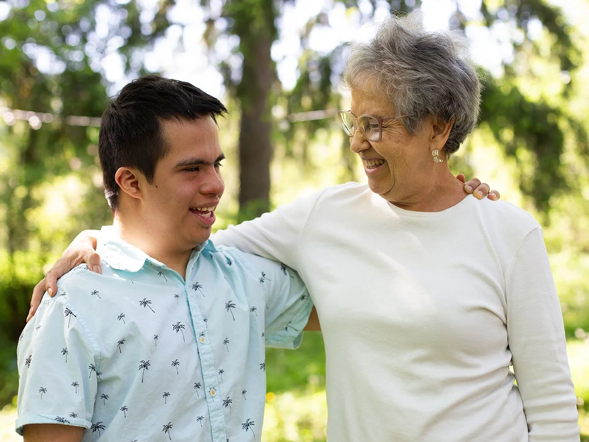 A man living with younger onset dementia and Down syndrome receiving one-on-one support at the Tide and Times café.