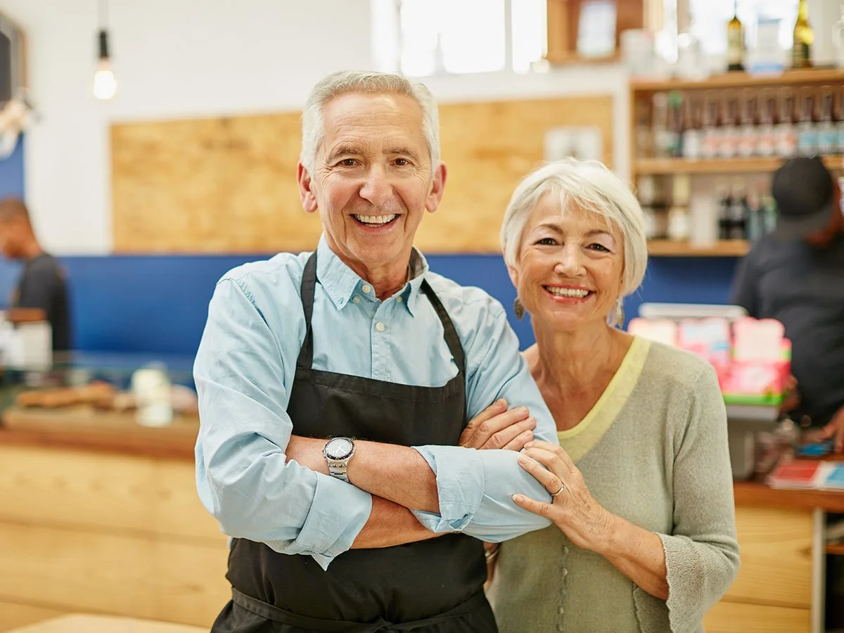 A man and a woman who are volunteering at the Tide & Times dementia cafe.