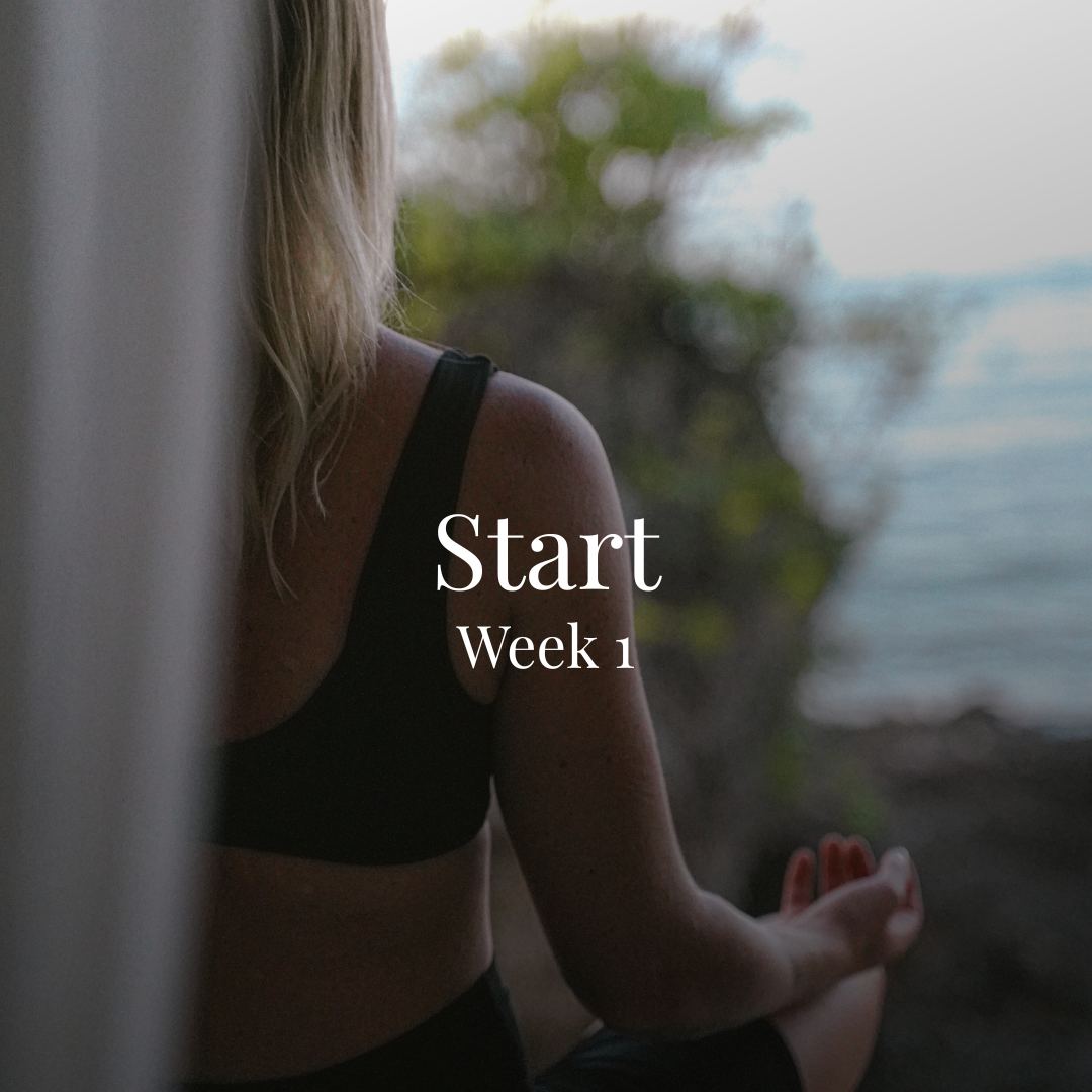 Person practicing yoga outdoors near a body of water, sitting in a meditative pose, with the words 'Start Week 1' overlayed on the image.