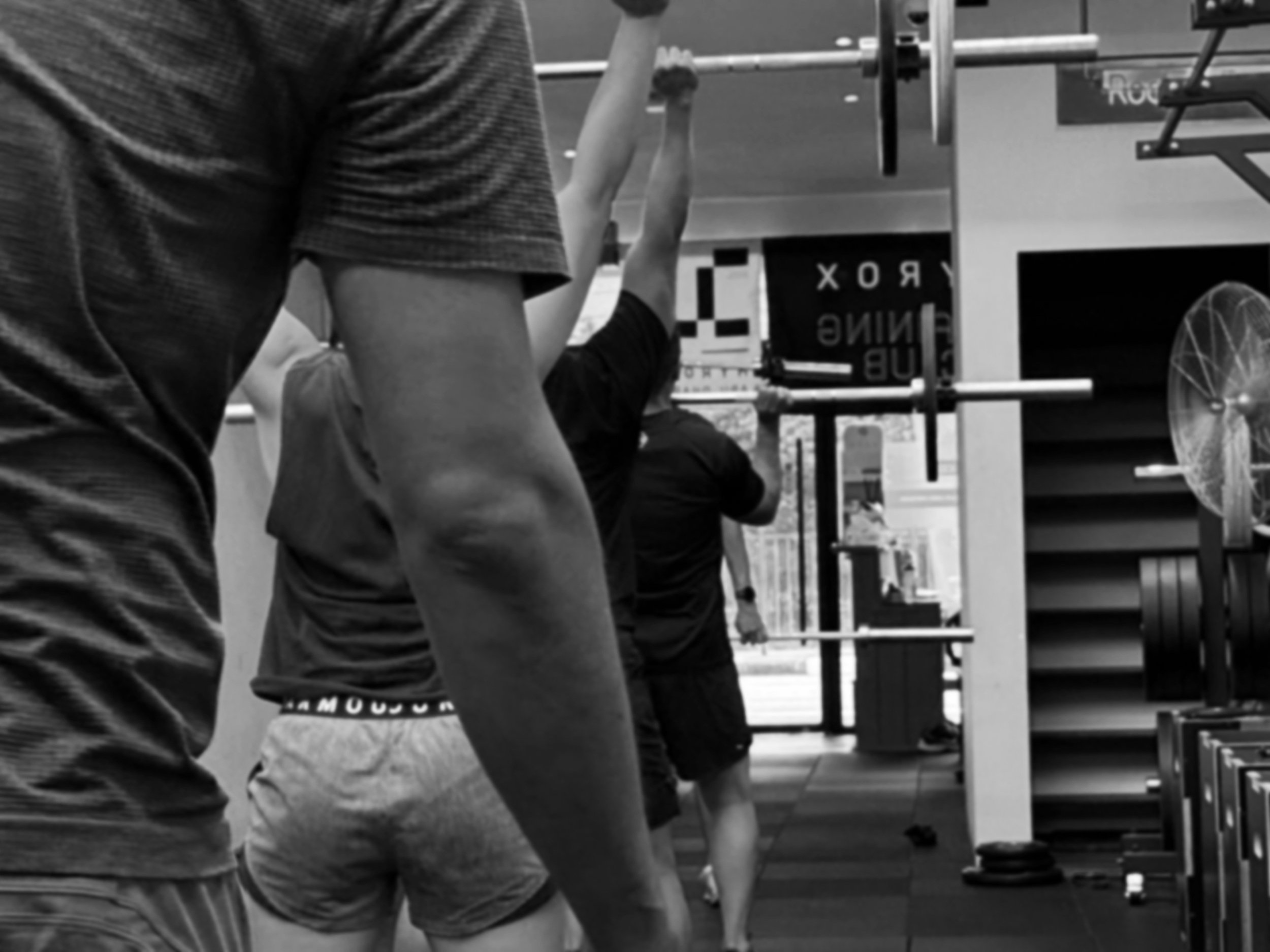 Members training with barbells in a coach-led weightlifting class in Balestier Singapore gym