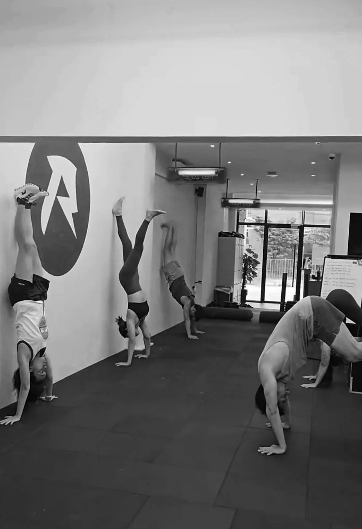 Calisthenics class performing wall handstands at a Balestier Singapore gym
