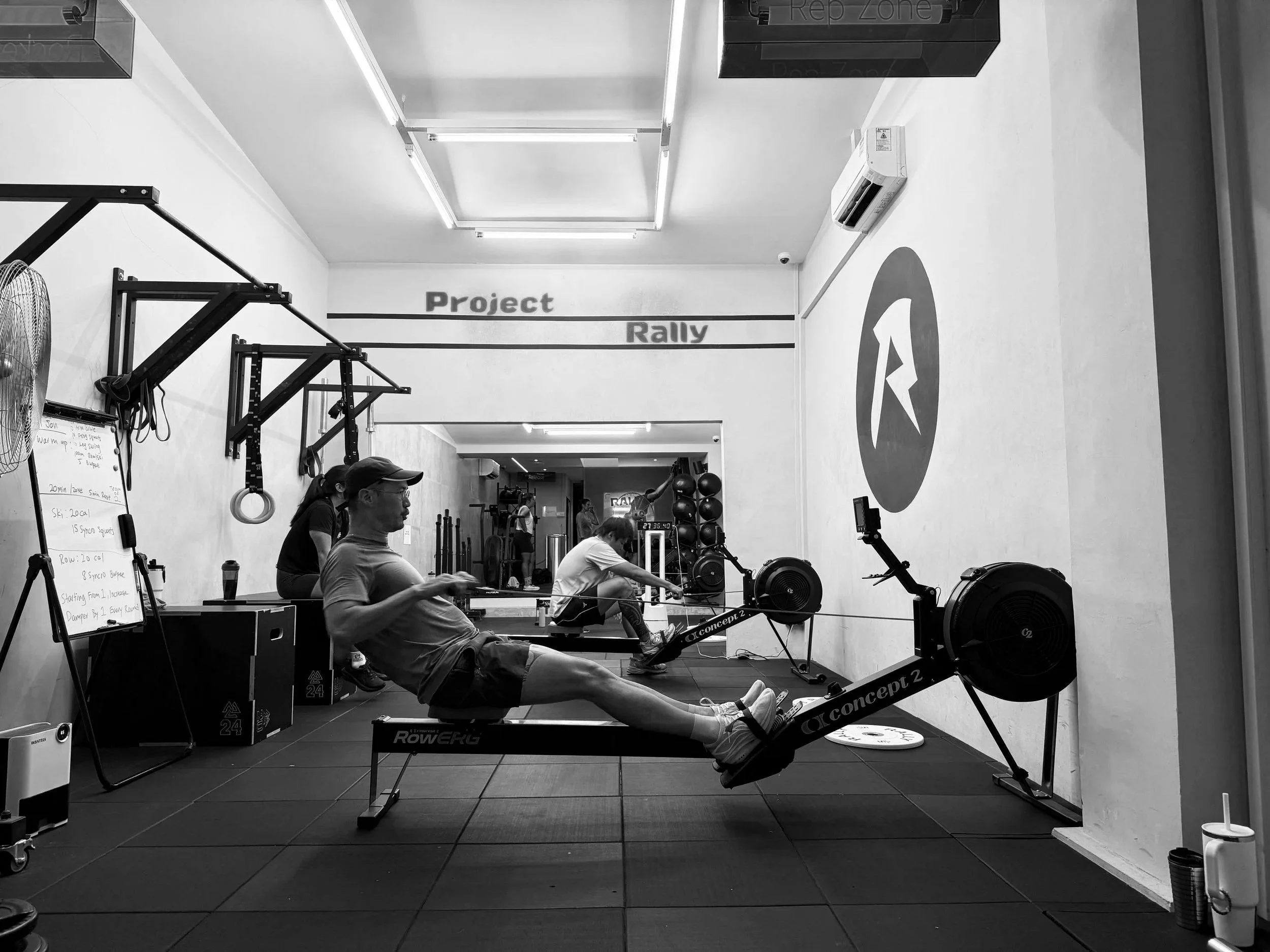 Group performing rowing intervals in a Nitro fitness class at a Balestier Singapore hybrid training gym