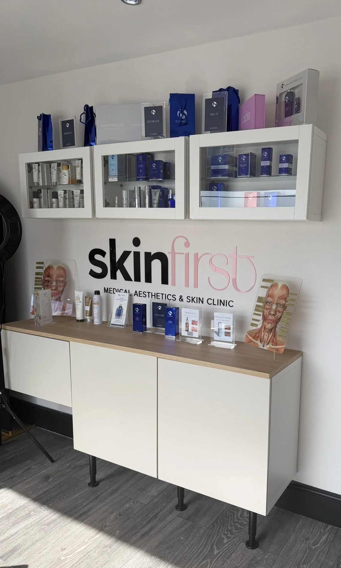 Inside SkinFirst clinic in Warrington, with the SkinFirst logo and professional skincare display