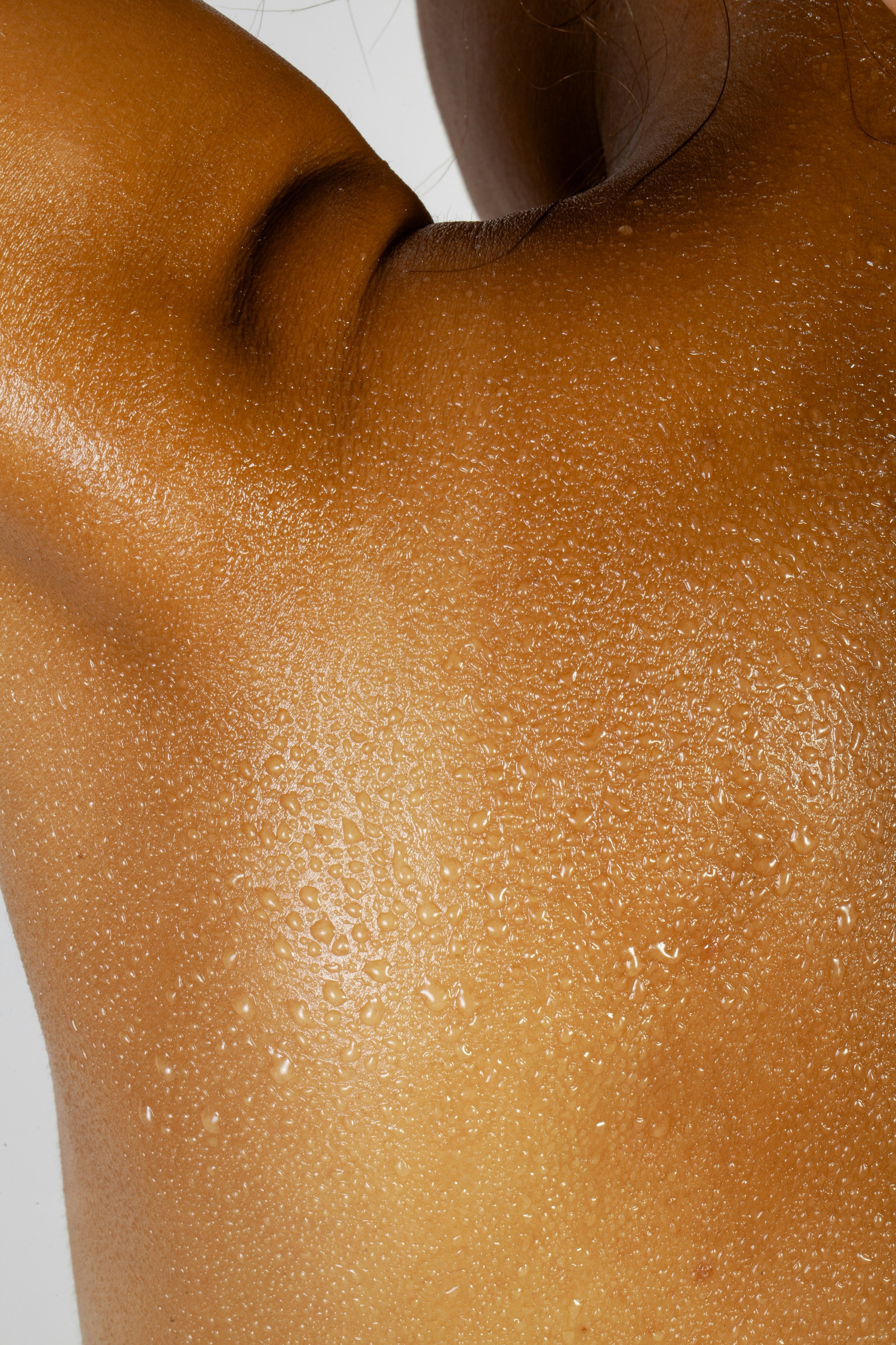 Healthy hydrated skin close-up with water droplets representing skin boosters including Profhilo, SkinVive and Jalupro Young Eyes at SkinFirst Warrington