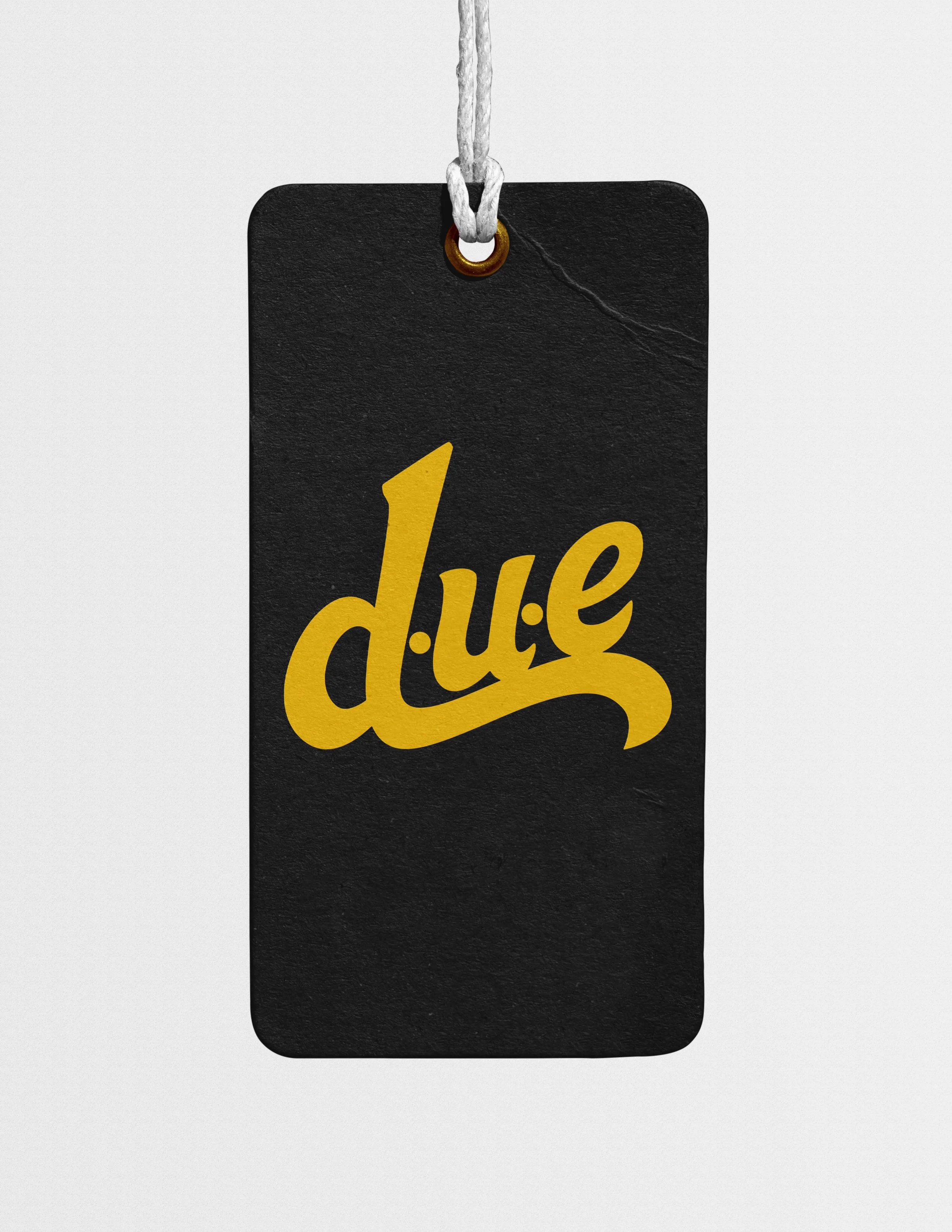 A black rectangular tag with the yellow words "d!ue" in stylized font, attached by a white cord looped through a gold eyelet.