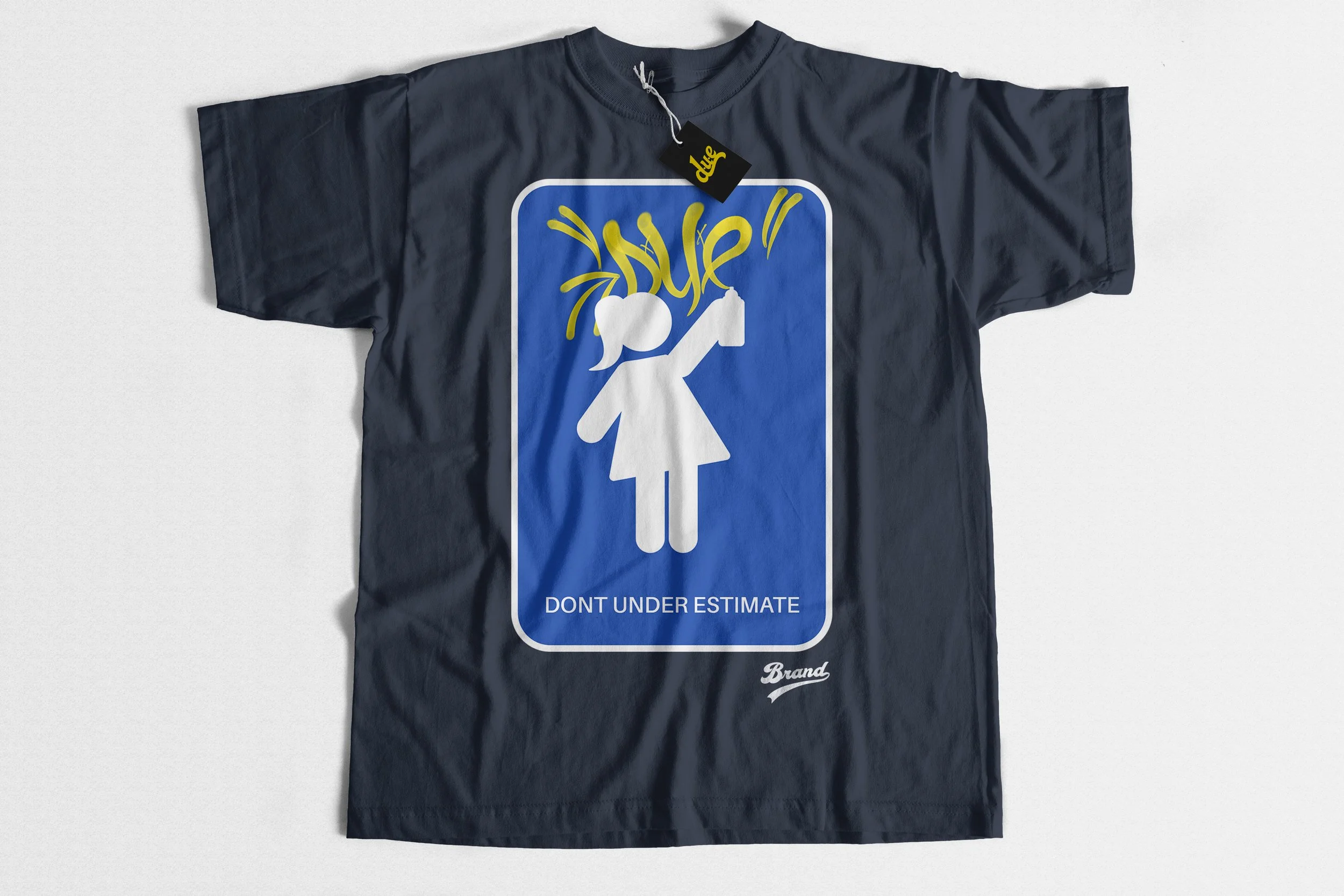 A dark-colored T-shirt with a graphic that mimics a road sign showing a female figure, with the text 'DON'T UNDERESTIMATE' below. The graphic also includes a stylized yellow signature or logo.