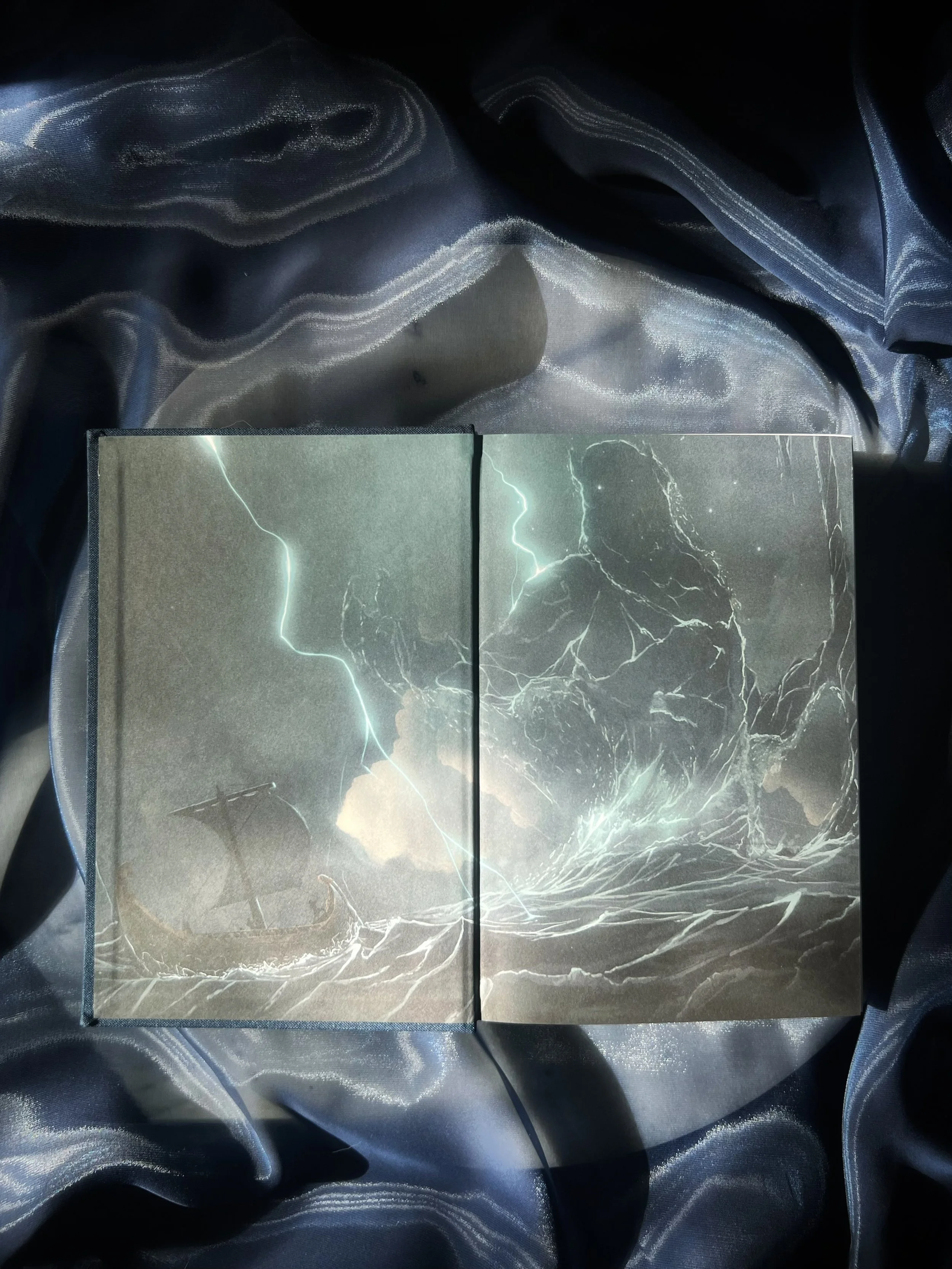 Illustrated endpapers inside The Odyssey collector’s edition showing a dramatic mythological seascape.