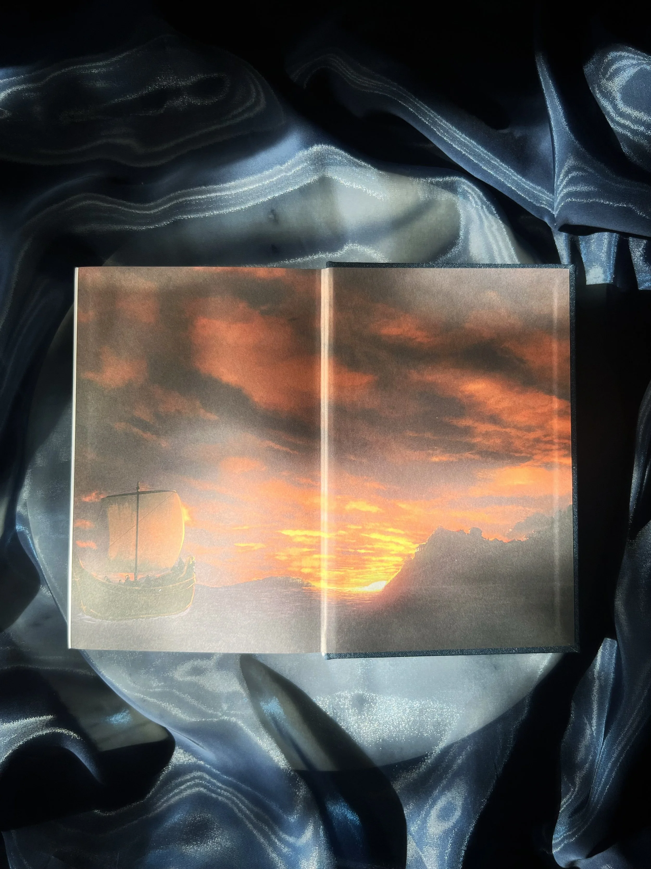 Exclusive illustrated artwork from The Odyssey collector’s edition showing a golden sunset over the sea.