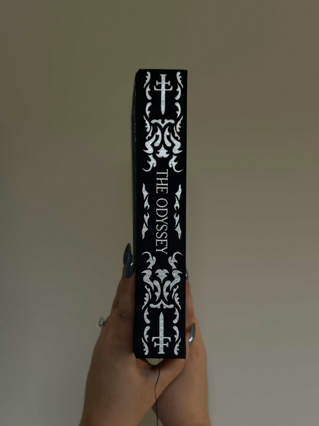 Spine of The Odyssey collector’s edition showing ornate silver foil detailing and title design.