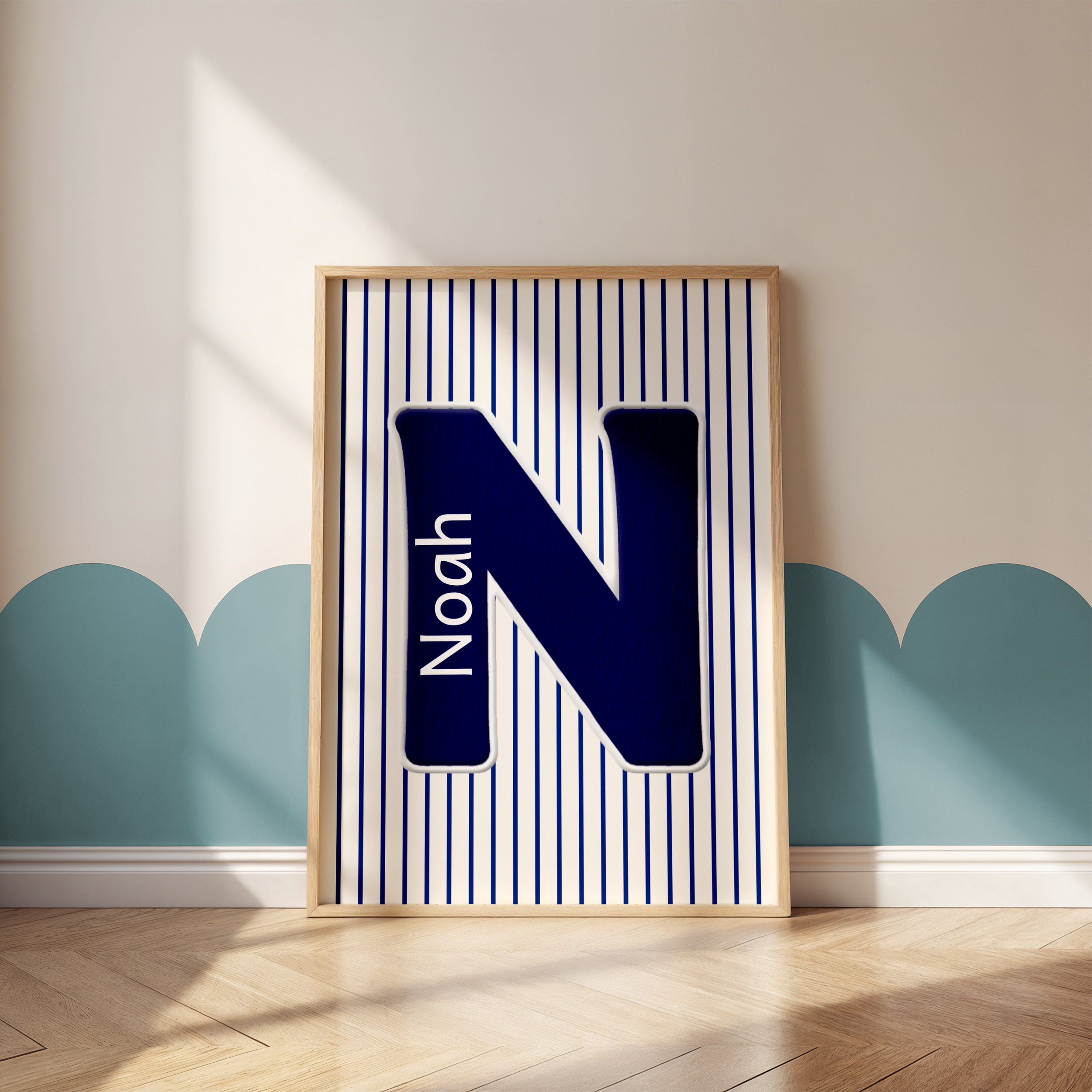 Framed artwork with blue and white stripes leaning against a plain beige wall with light wood flooring.