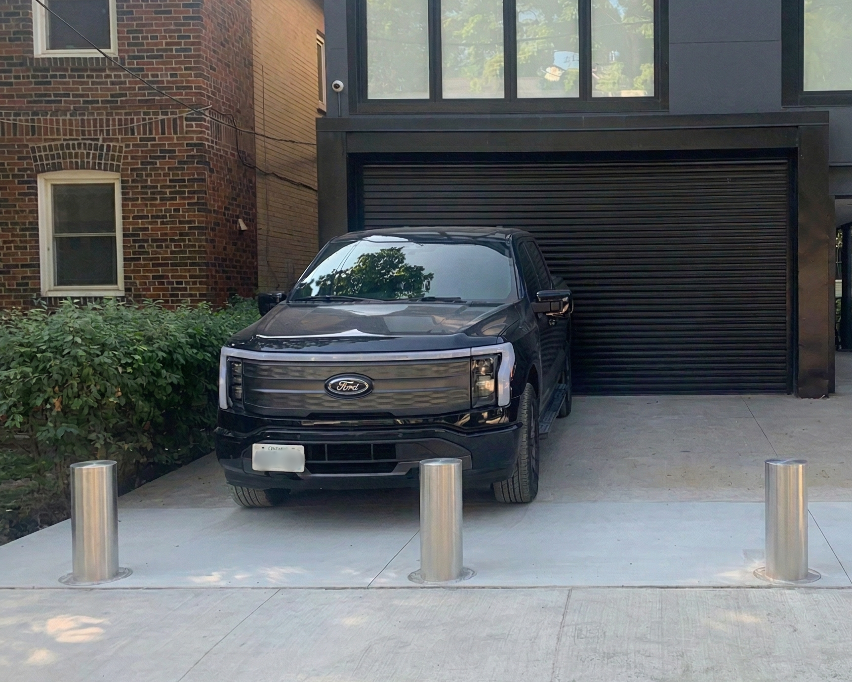 Automatic Stainless Steel Bollard Protecting Truck in Driveway in Toronto and GTA