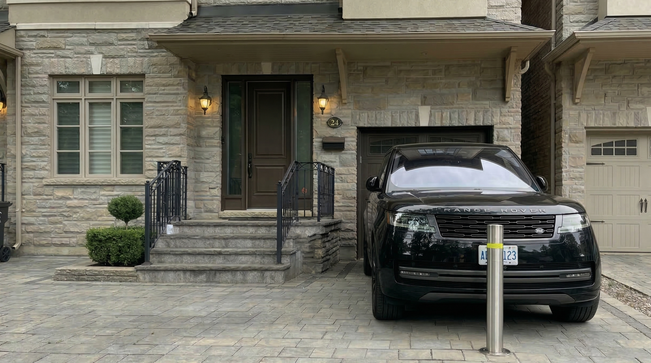Heavy-duty driveway security bollard installed in front of a vehicle in Toronto to prevent keyless auto theft.