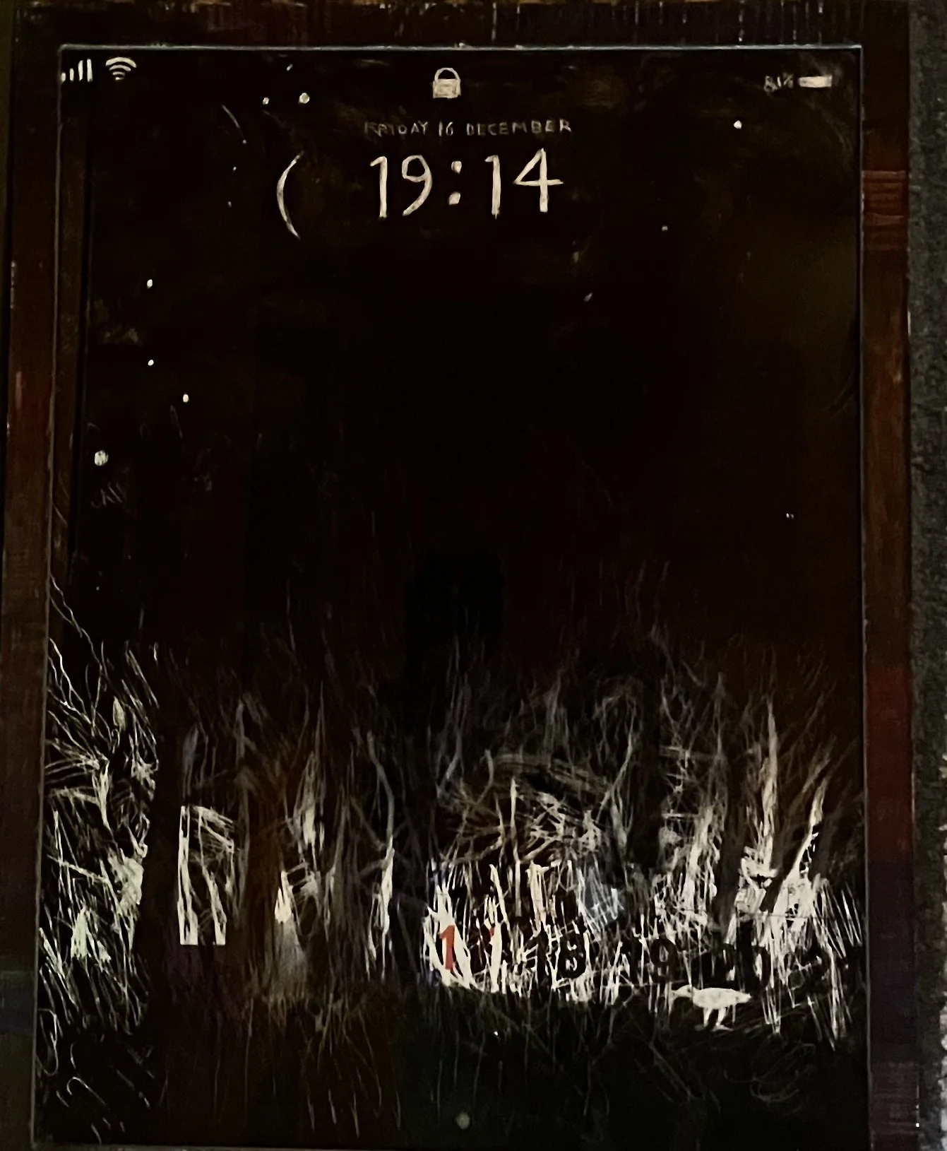 A mirror with visible scratches and marks, displaying a digital clock showing 19:14, the date December 16, and some icons and text at the top.