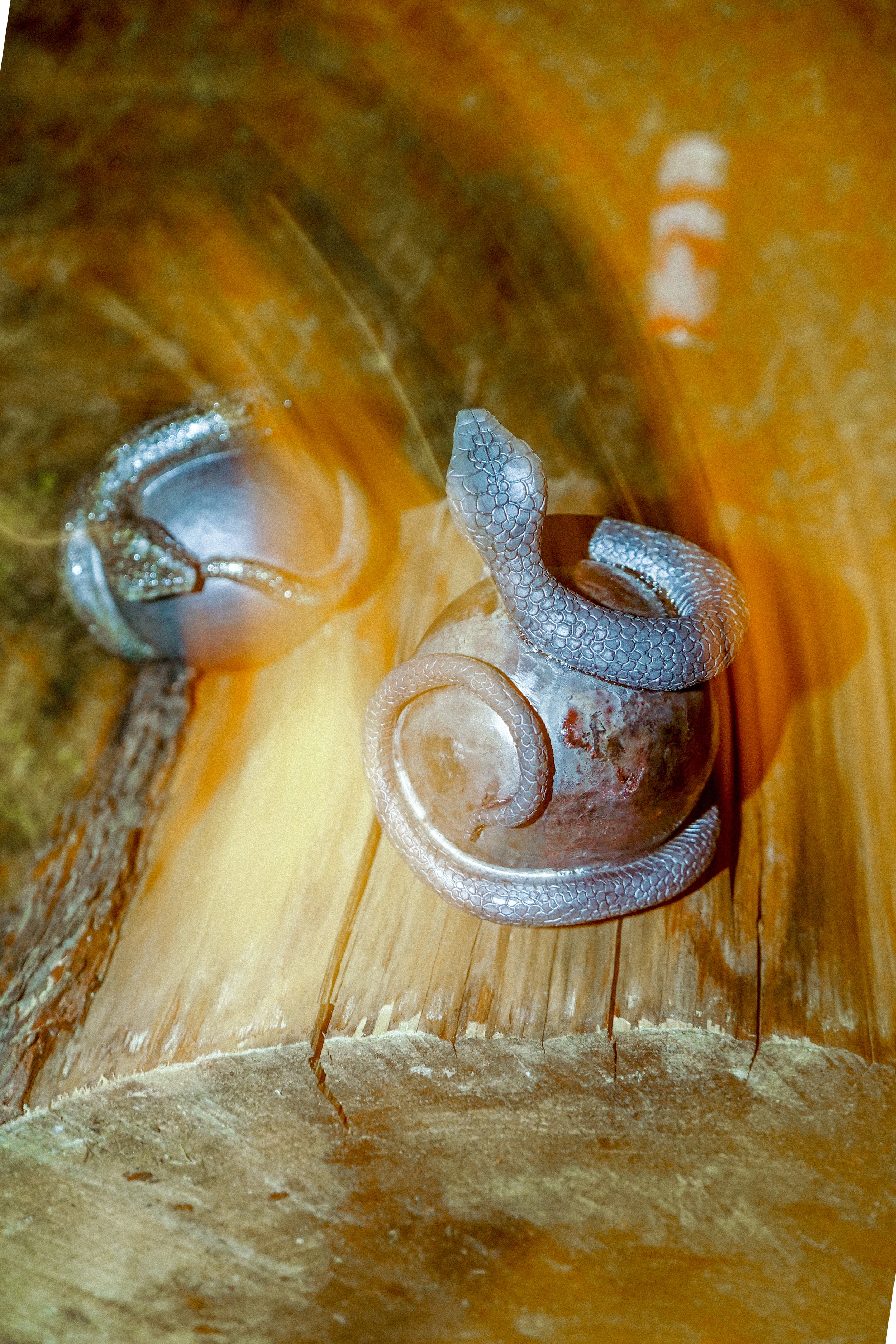 ceramic snake on top of an orb