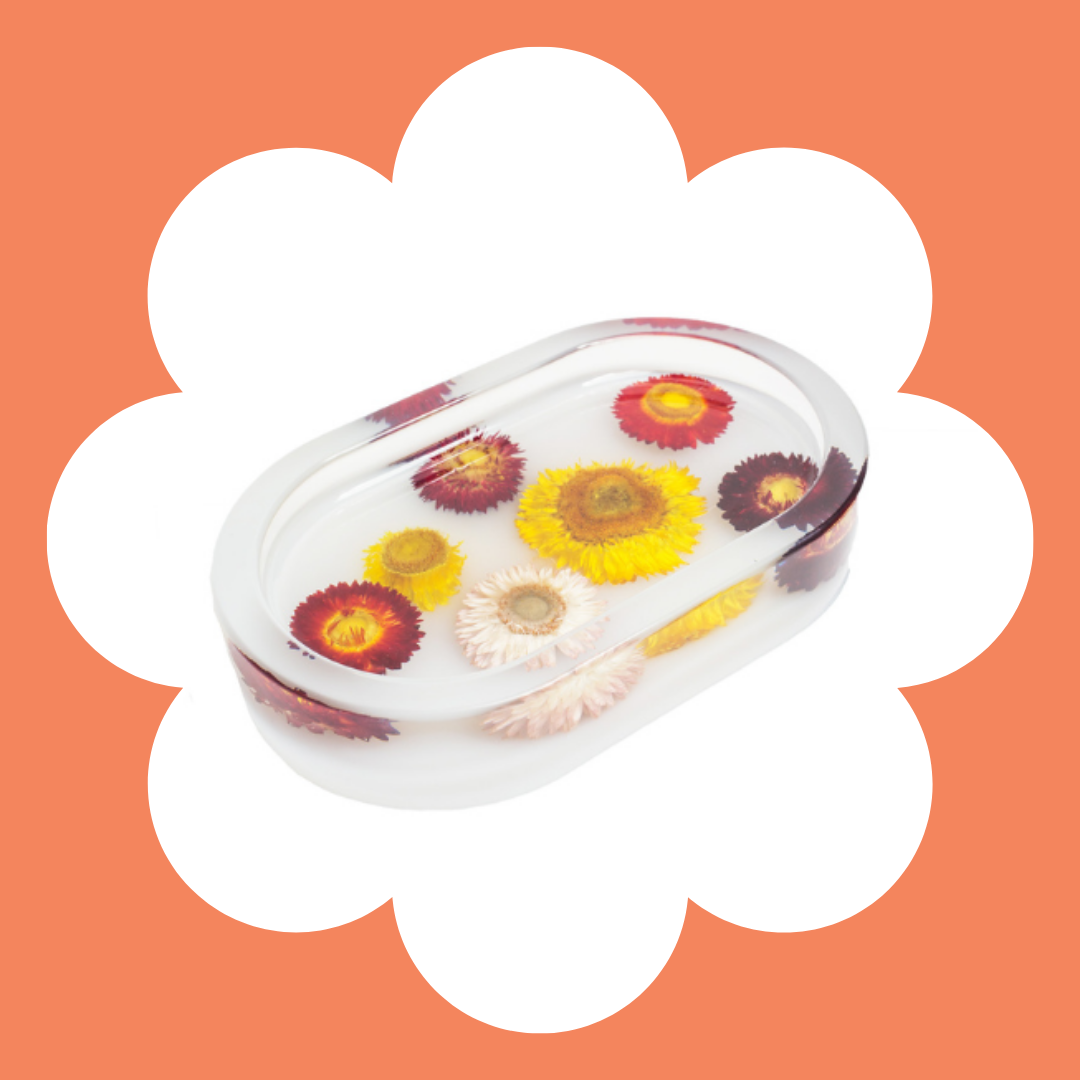 A resin trinket tray with peach background.