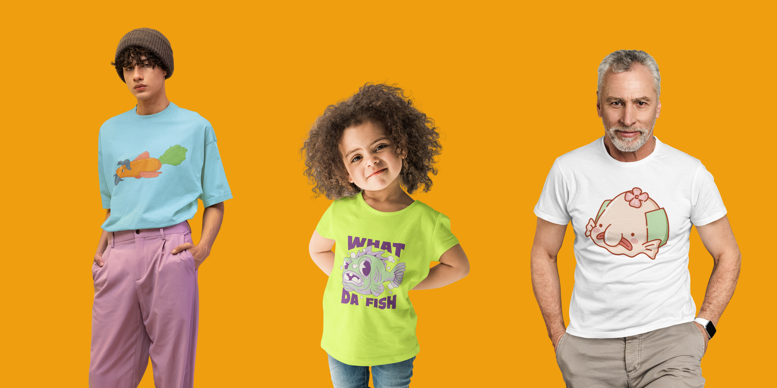 Three people standing against a yellow background, showcasing colorful graphic t-shirts. A young woman on the left in a blue t-shirt with a fish graphic wearing a brown beanie and pink pants. A young girl in the middle with curly hair wearing a bright green t-shirt with a fish graphic and the text 'What Da Fish.' An older man on the right with gray hair and beard wearing a white t-shirt with a cute pink pig graphic and beige pants.