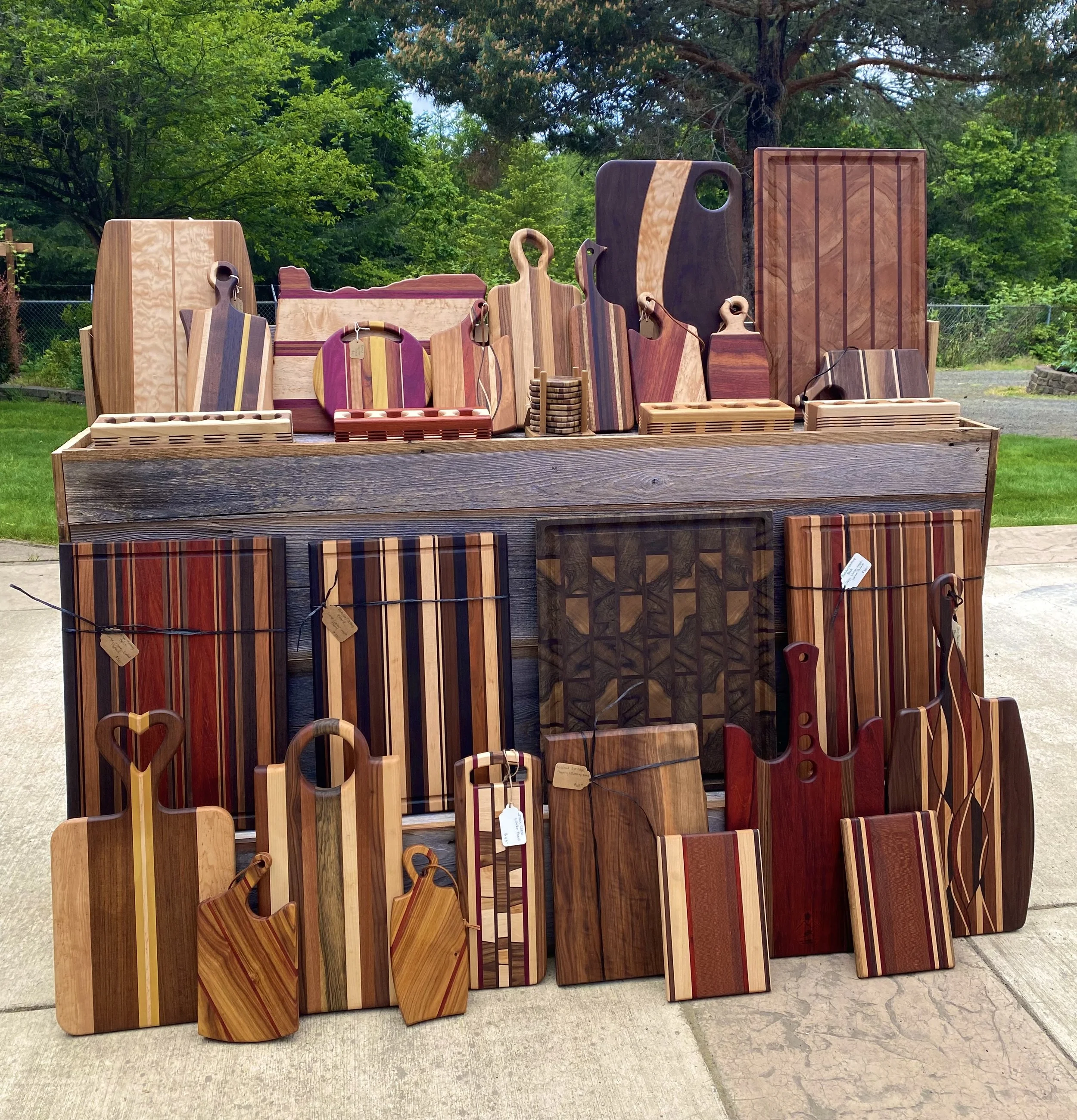 A display of wooden cutting boards and chopping blocks in various shapes, sizes, and wood grains.