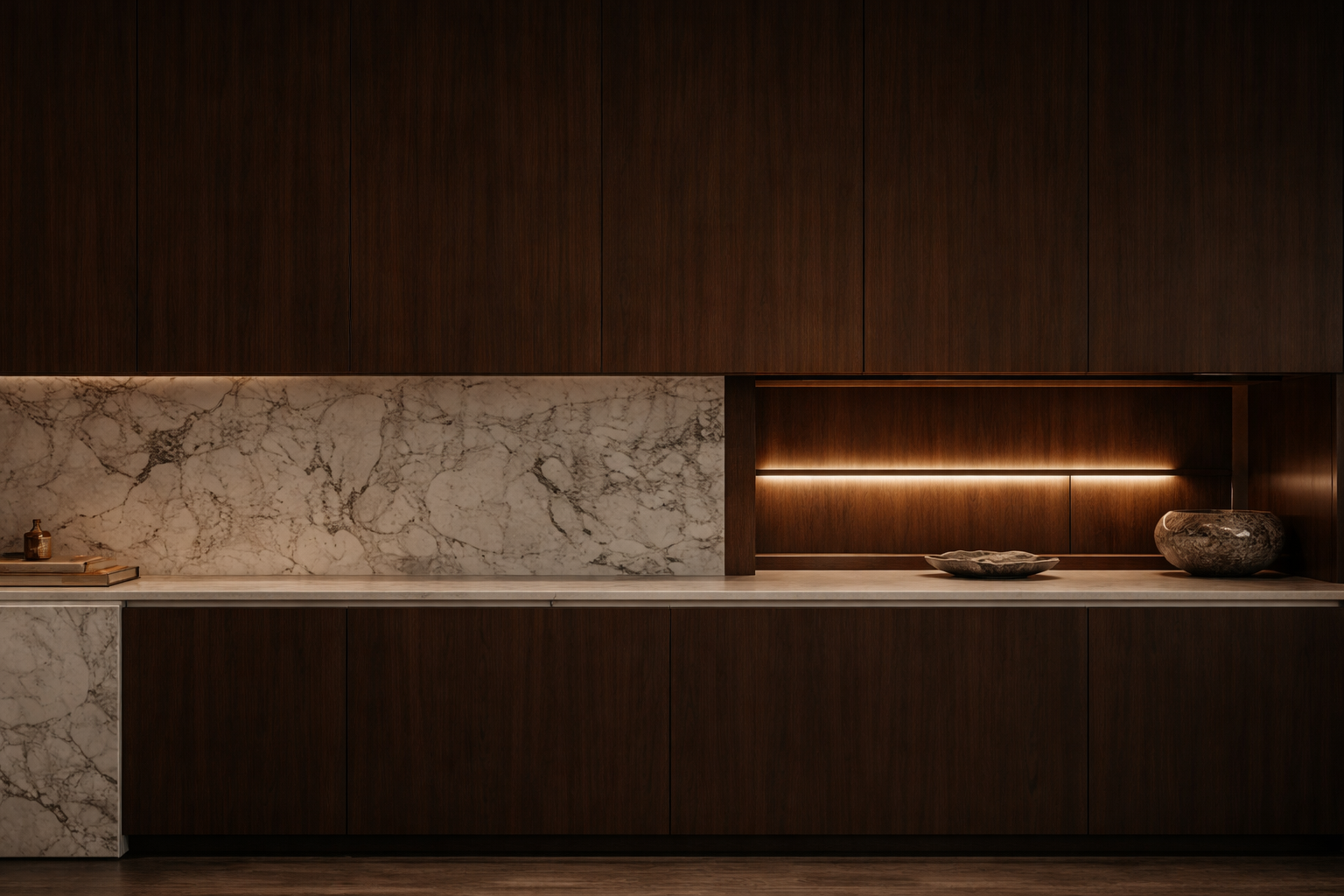 Modern kitchen with dark wood cabinets, marble backsplash, and subtle lighting, with a few decorative bowls and books on the counter.