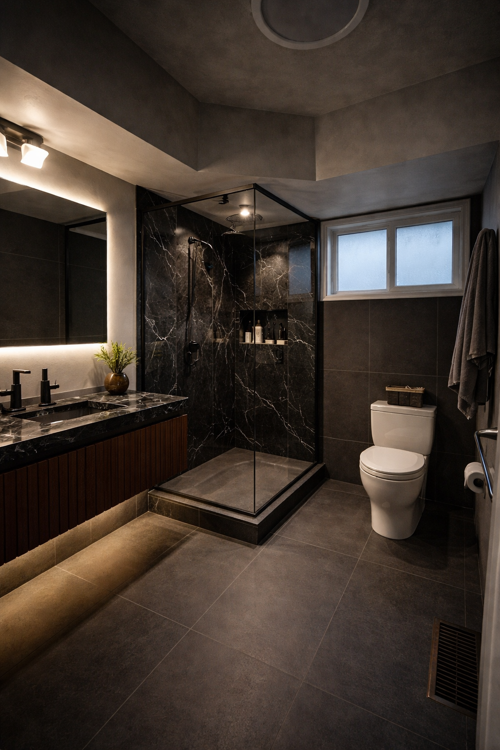 Modern bathroom with black marble shower, dark vanity with black sinks, white toilet, and frosted window.