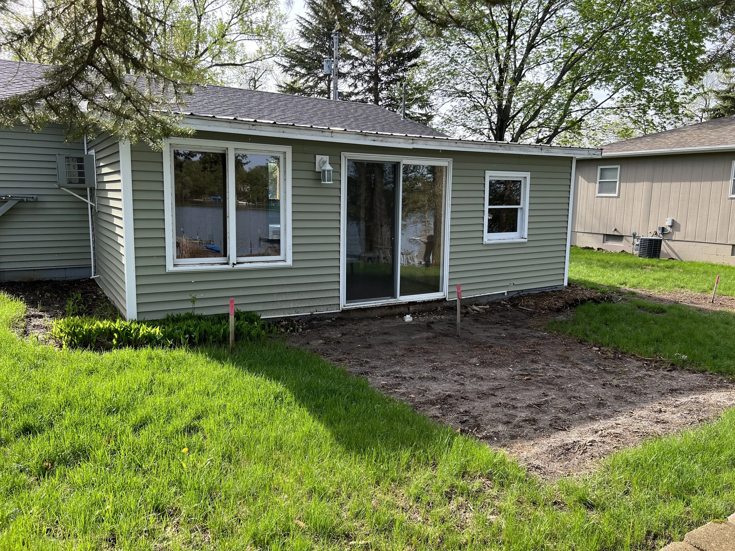 3 lake-home-before-exterior-siding-sliding-door-yard-prep.jpeg