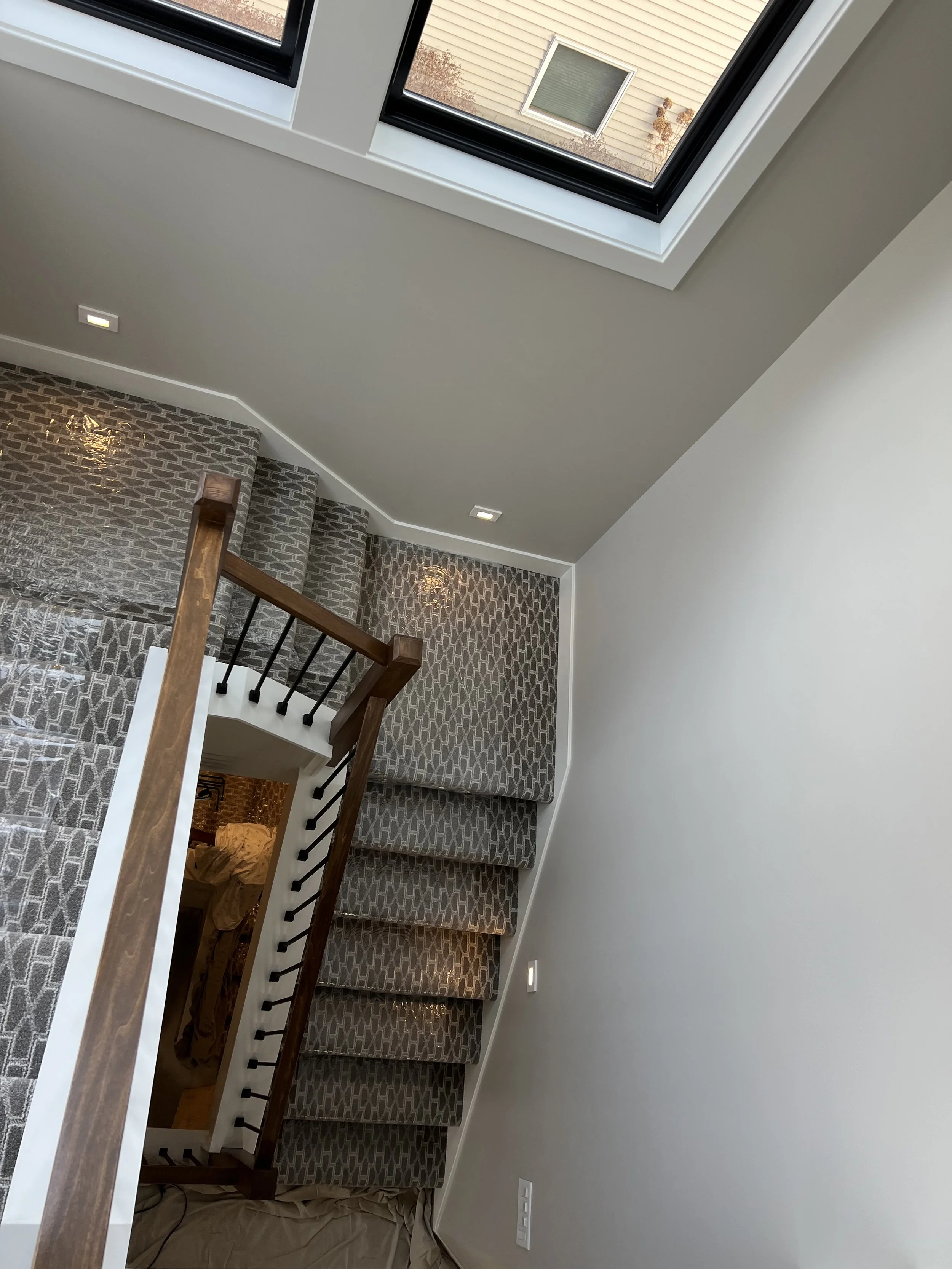 13 modern-home-staircase-carpet-wood-railing-finished.jpeg
